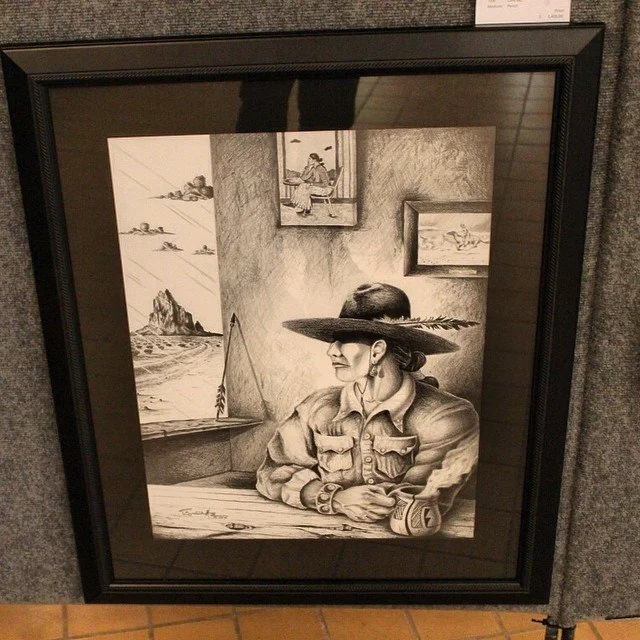 Framed black and white portrait drawing of a person with a broad-brimmed hat, looking out a window at the sea. Includes abstract details and framed pictures within the art.