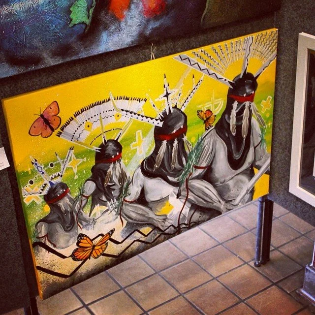 Colorful painting of four abstract Native American figures dressed in traditional attire, adorned with feathered headdresses and red headbands, set against a vibrant yellow background with white geometric patterns and butterflies.