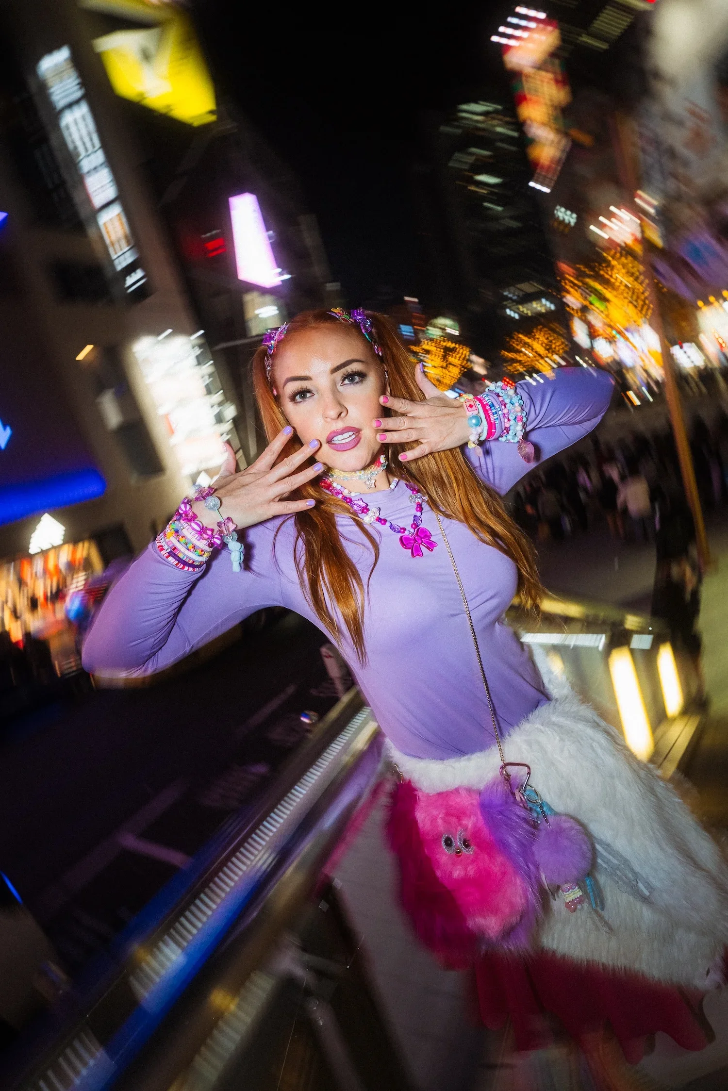Woman posing among vibrant Shibuya city lights during a creative Tokyo street style photoshoot