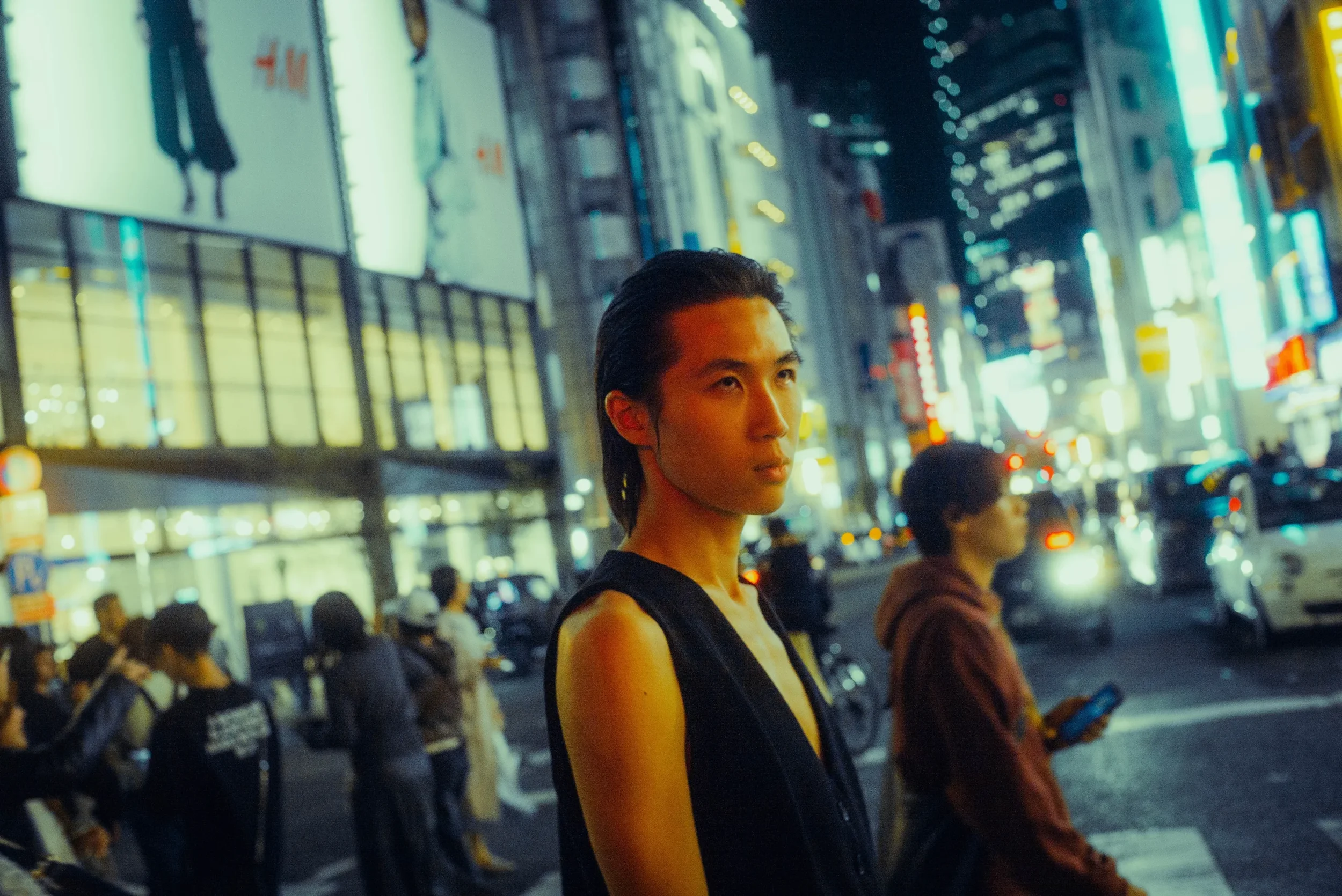 Solo portrait on a busy Tokyo street during a cinematic night photoshoot