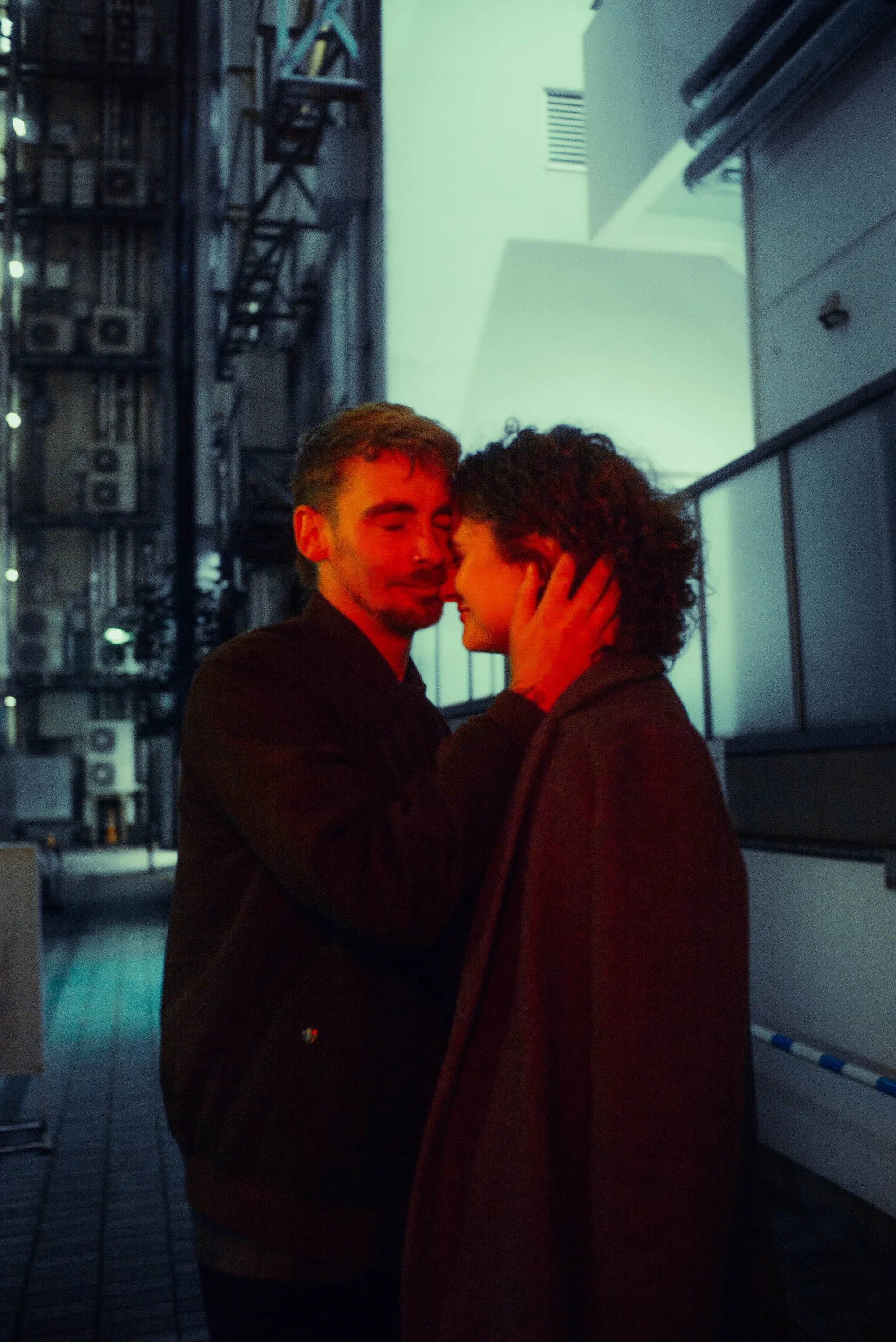 Couple sharing an intimate moment during a cinematic Tokyo night photoshoot
