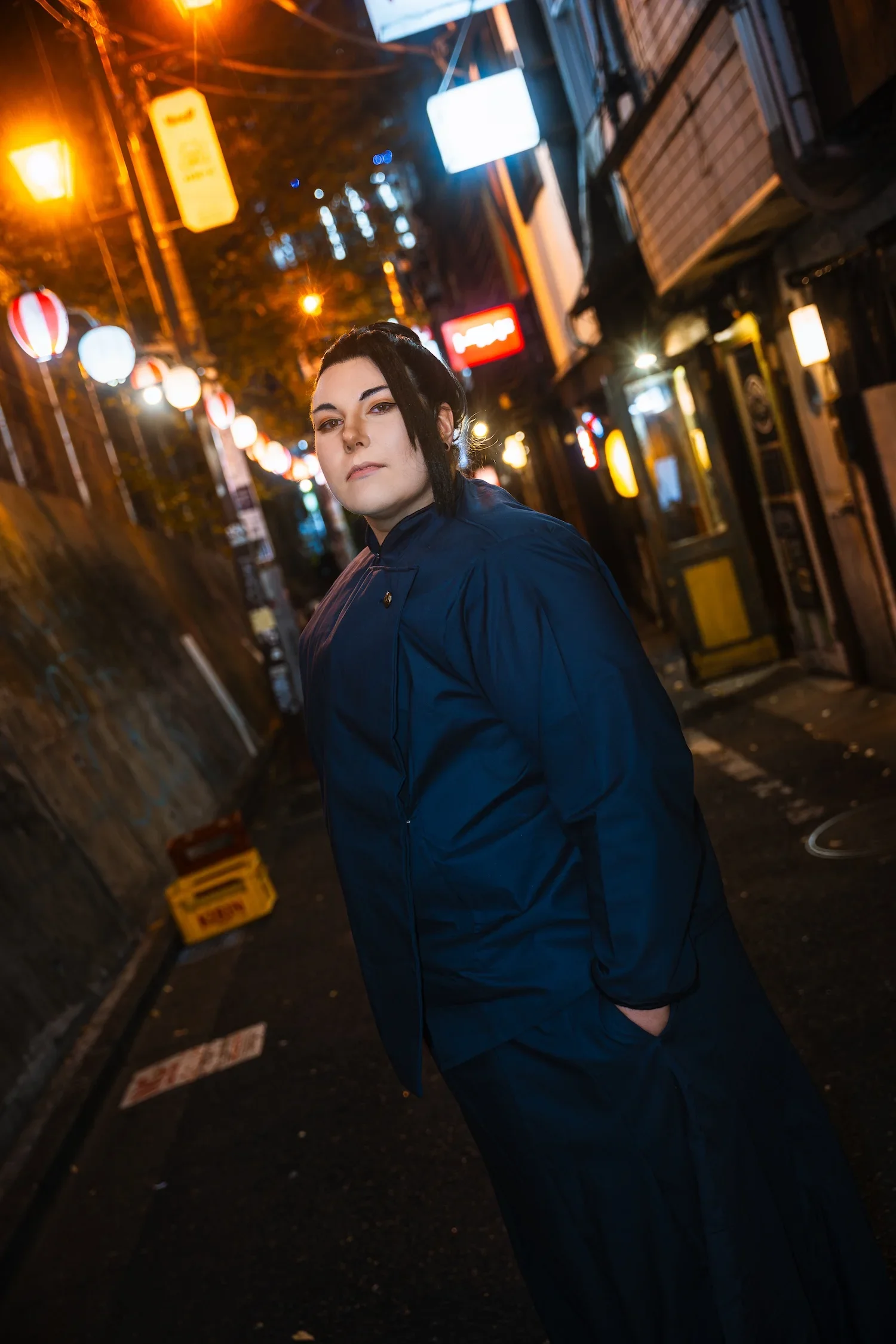 Street style portrait in a lantern-lit Tokyo alley during a professional night photoshoot