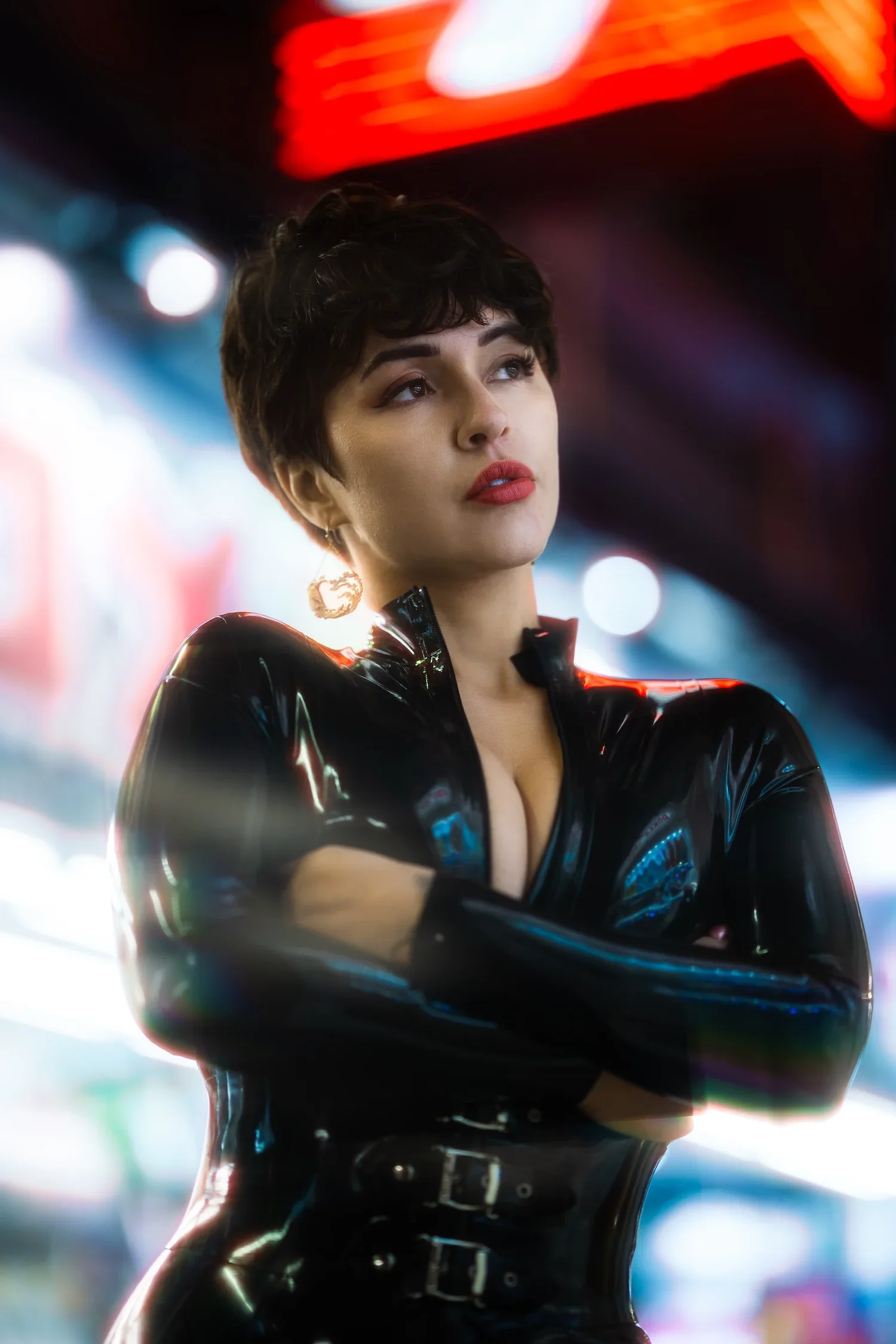 Woman in black fashion styling photographed against neon lights during a professional Tokyo night portrait photoshoot