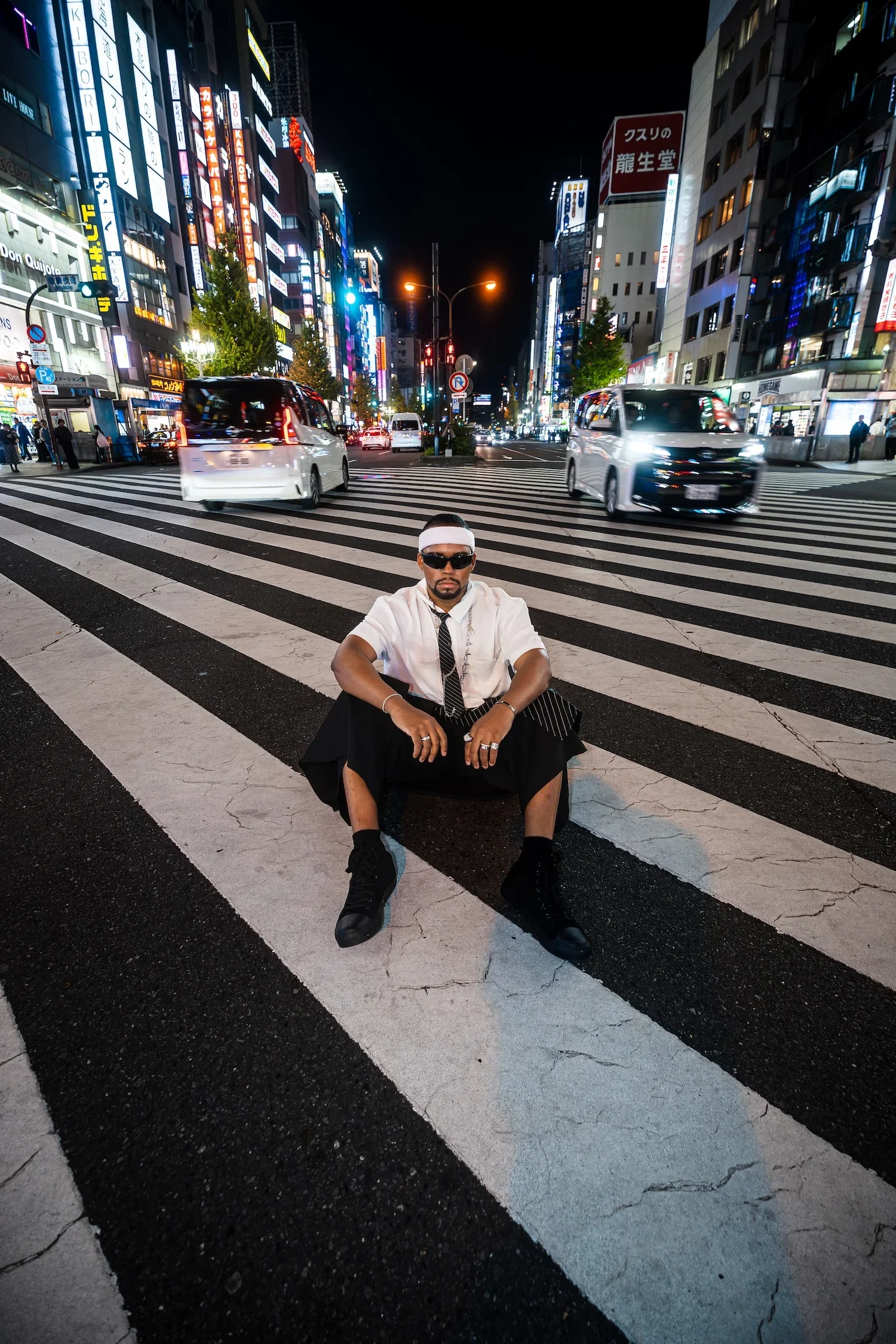 Man posing on Shibuya Crossing during a professional Tokyo street style portrait session