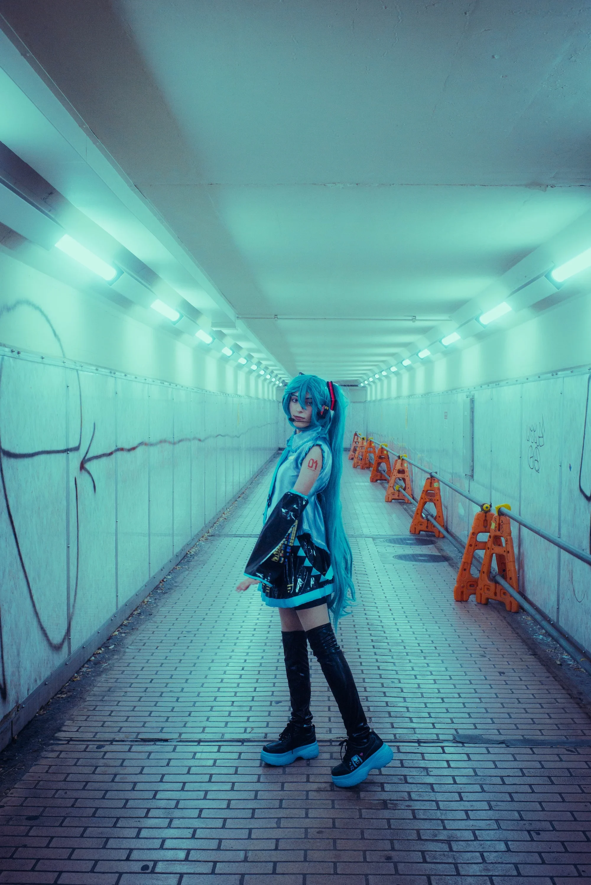 Creative solo portrait in a glowing underground Tokyo passage at night