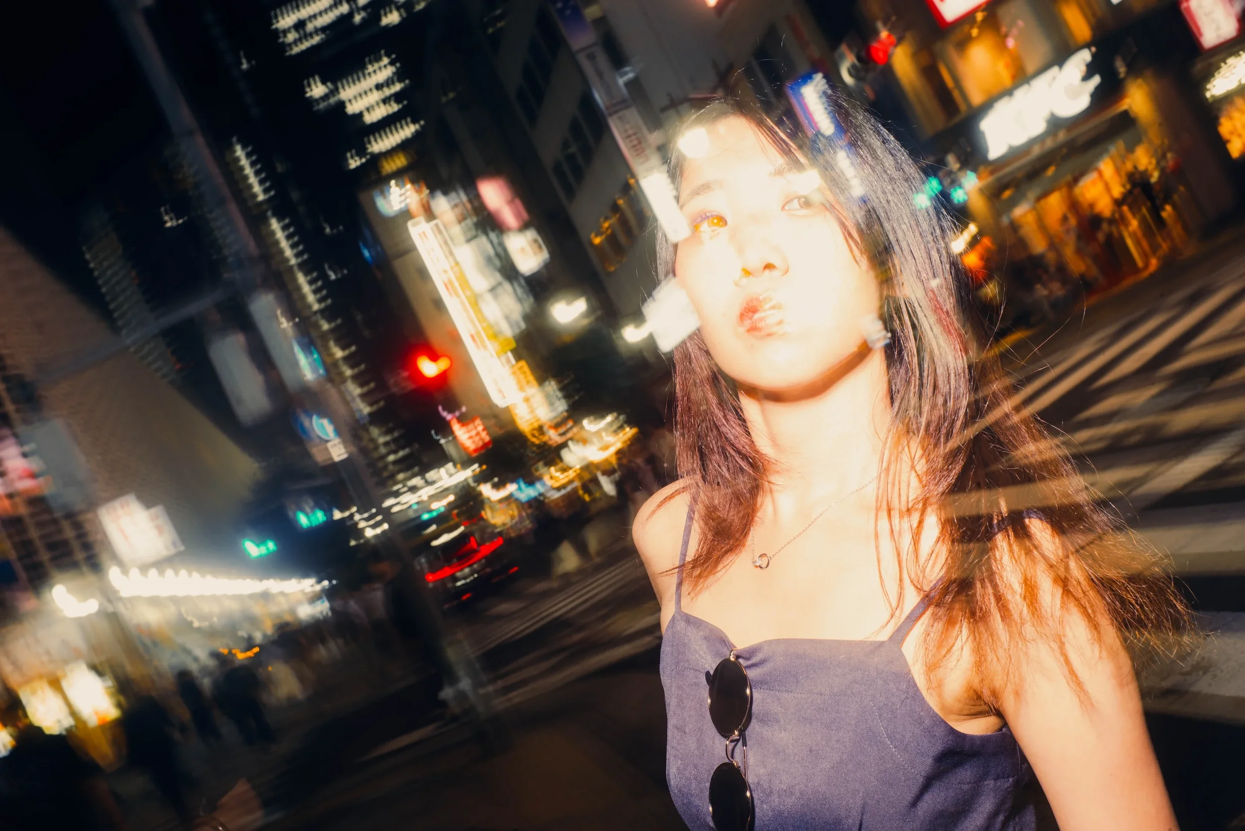 Creative portrait using motion blur and Tokyo city lights during an After Dark photoshoot