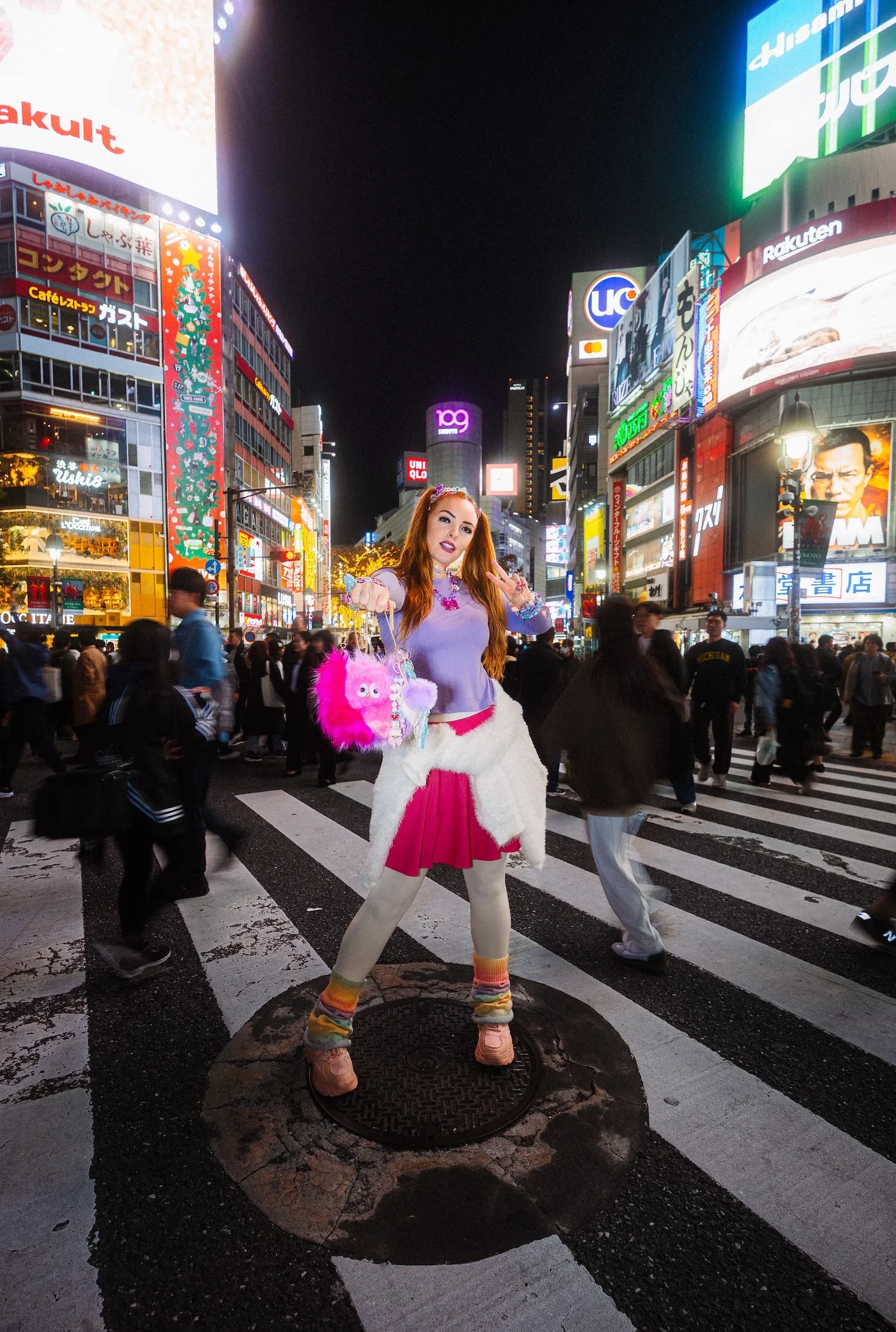 Woman posing at Shibuya Crossing during a professional Tokyo street style photoshoot