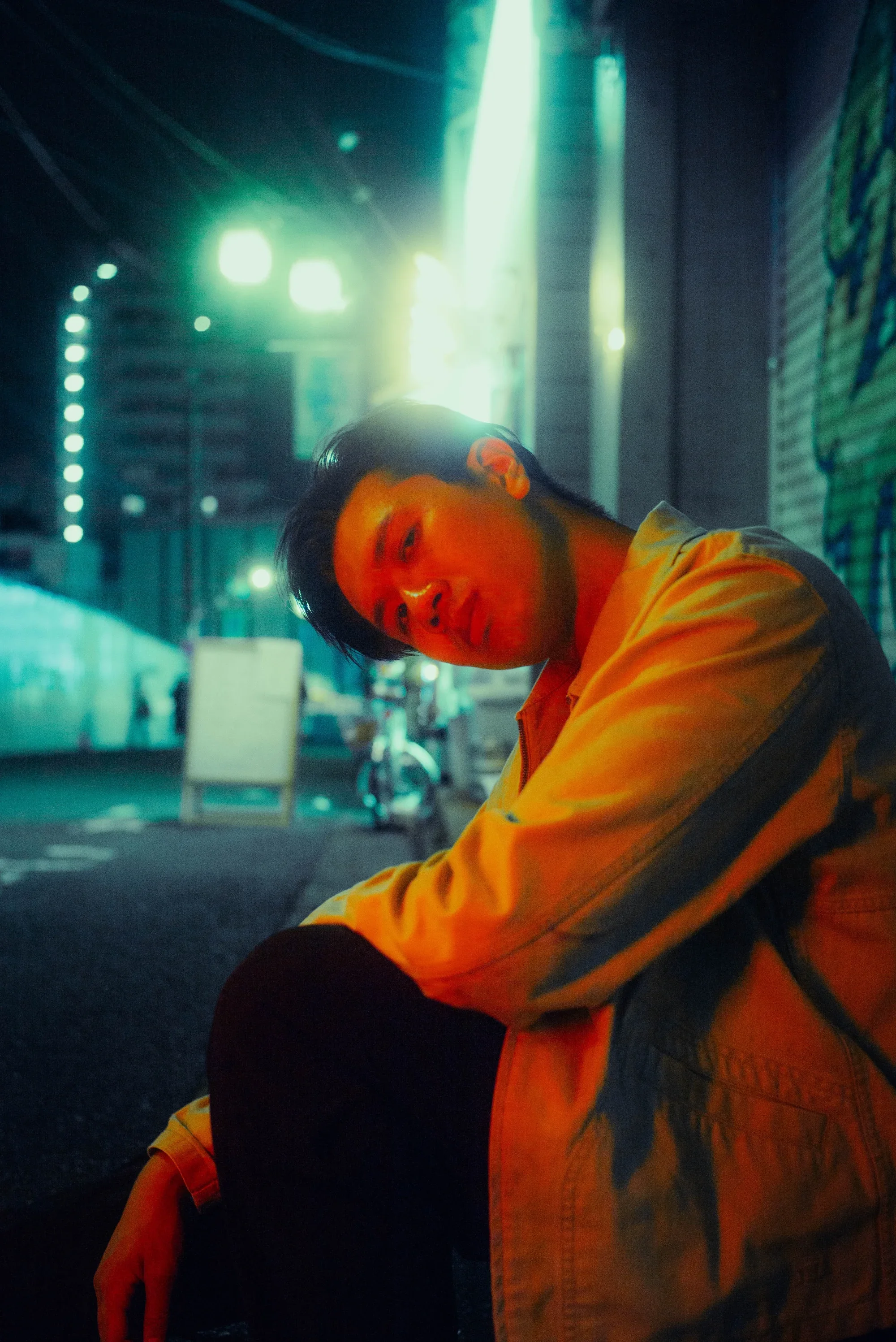 Solo portrait under glowing city lights during a cinematic Tokyo night photoshoot