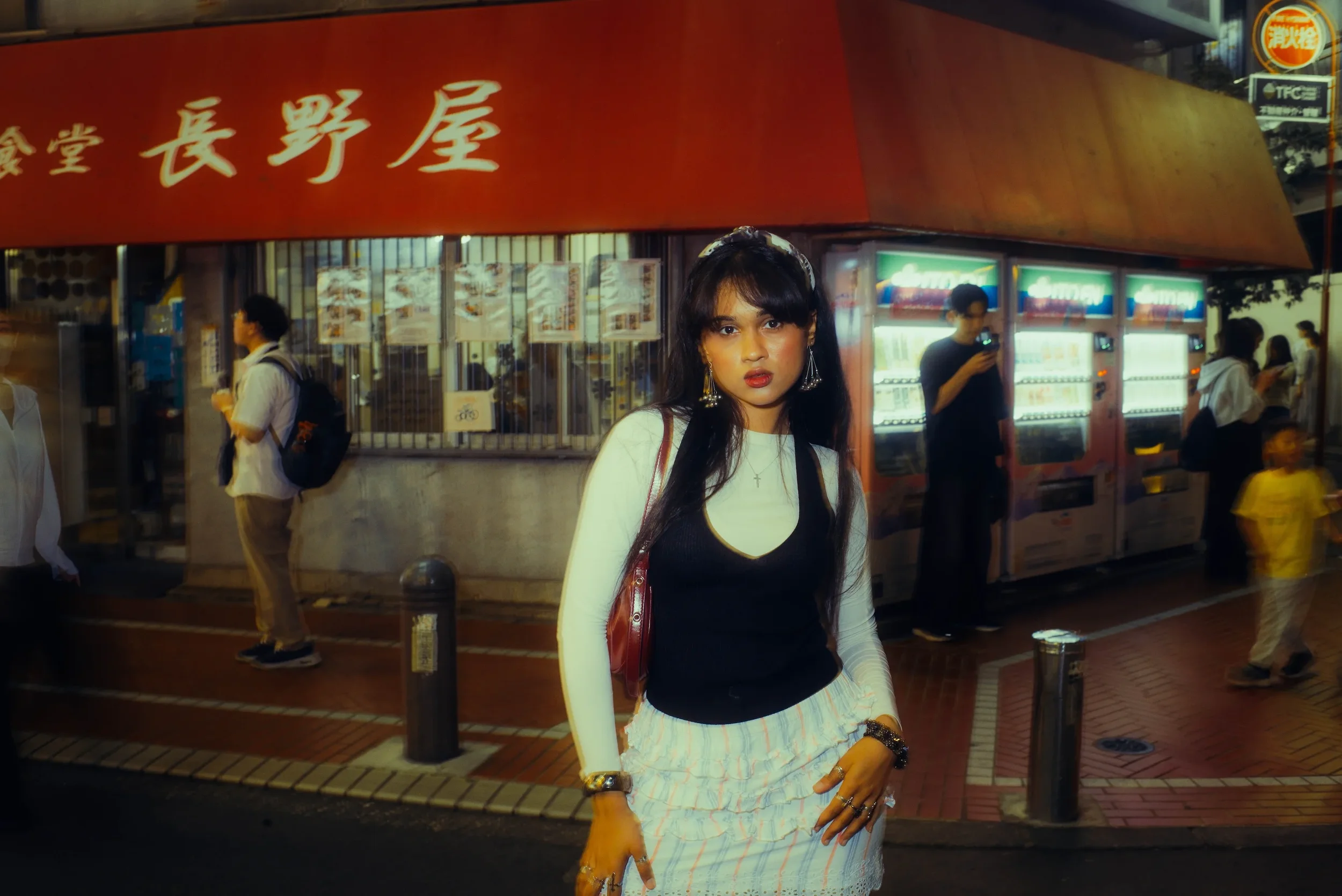 Street-style portrait outside a local Tokyo restaurant at night