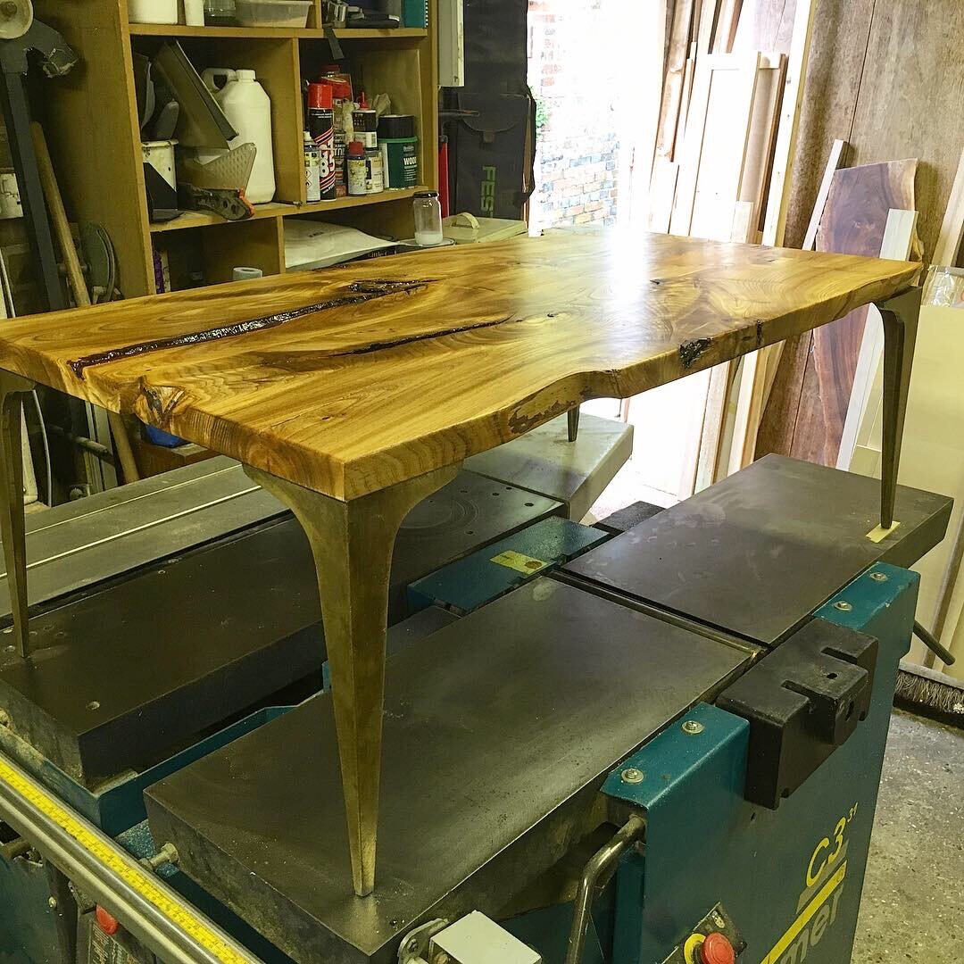 Book Matched English Elm Coffee Table on Bronze Stiletto legs