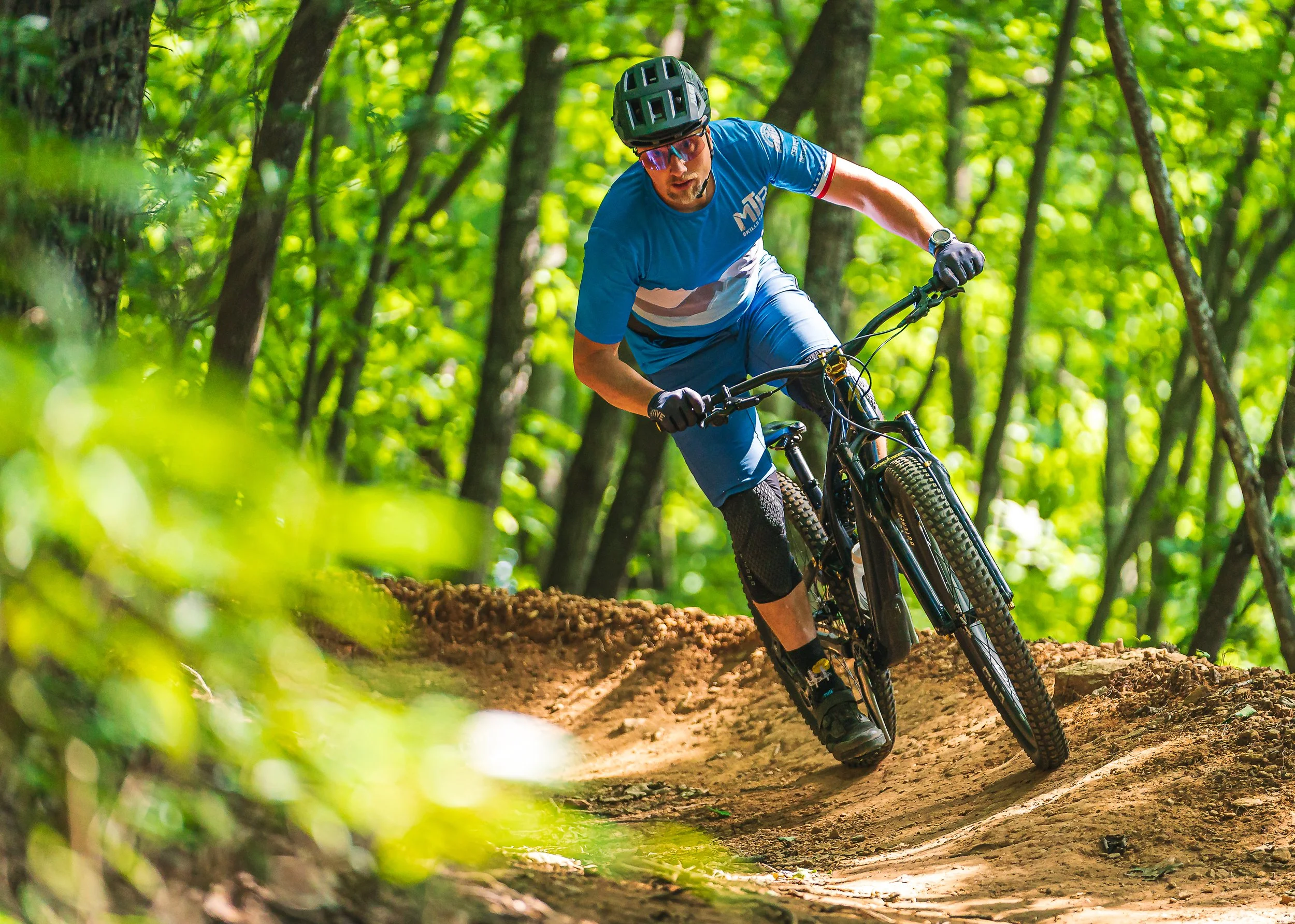 Mountain Biker rides a berm turn in the Old Fort Trail Region
