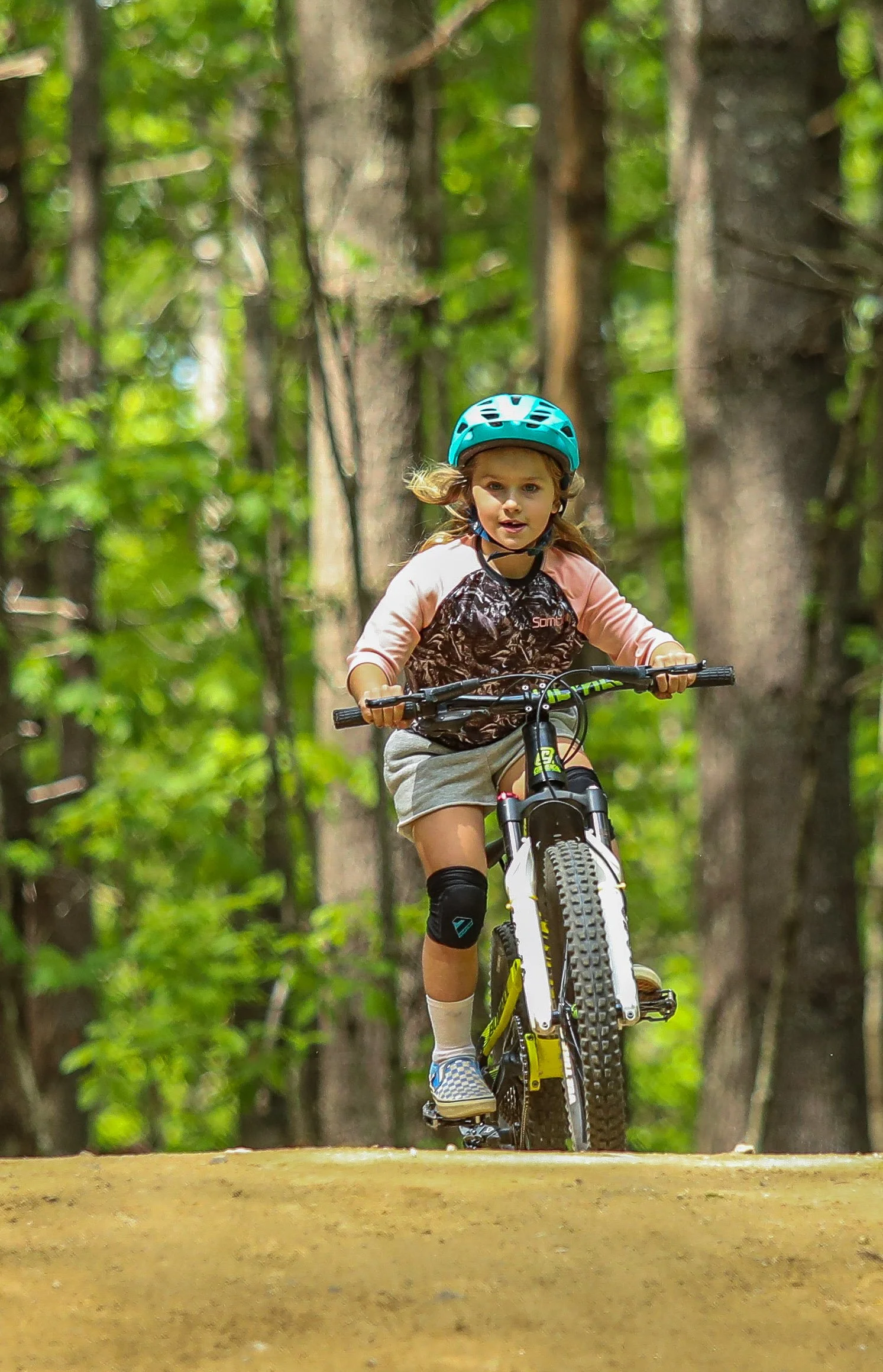 A kid rides a mountain bike during Kids mountain bike camp