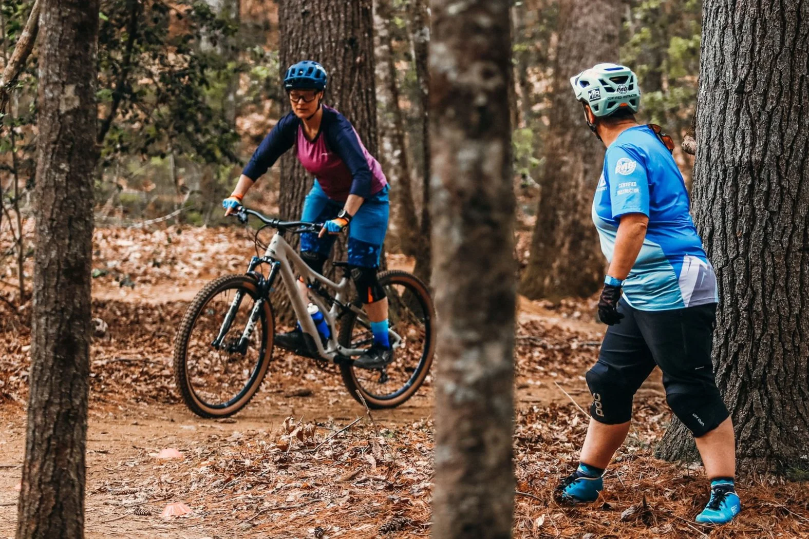 Whitney Houck watches a client ride a corner