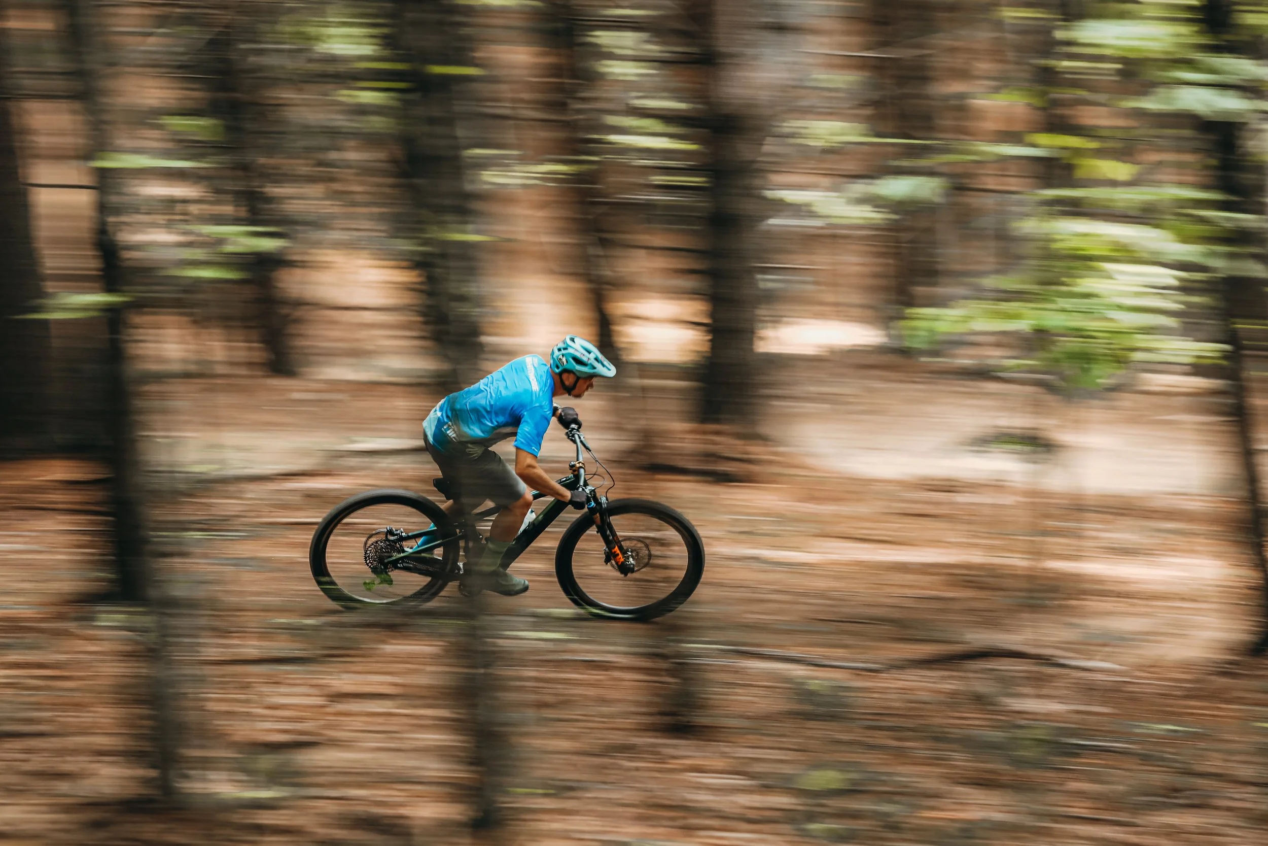 Top Rated Coach Josh Whitmore demonstrates a technique on trail during aMountain biking class on black rated trails