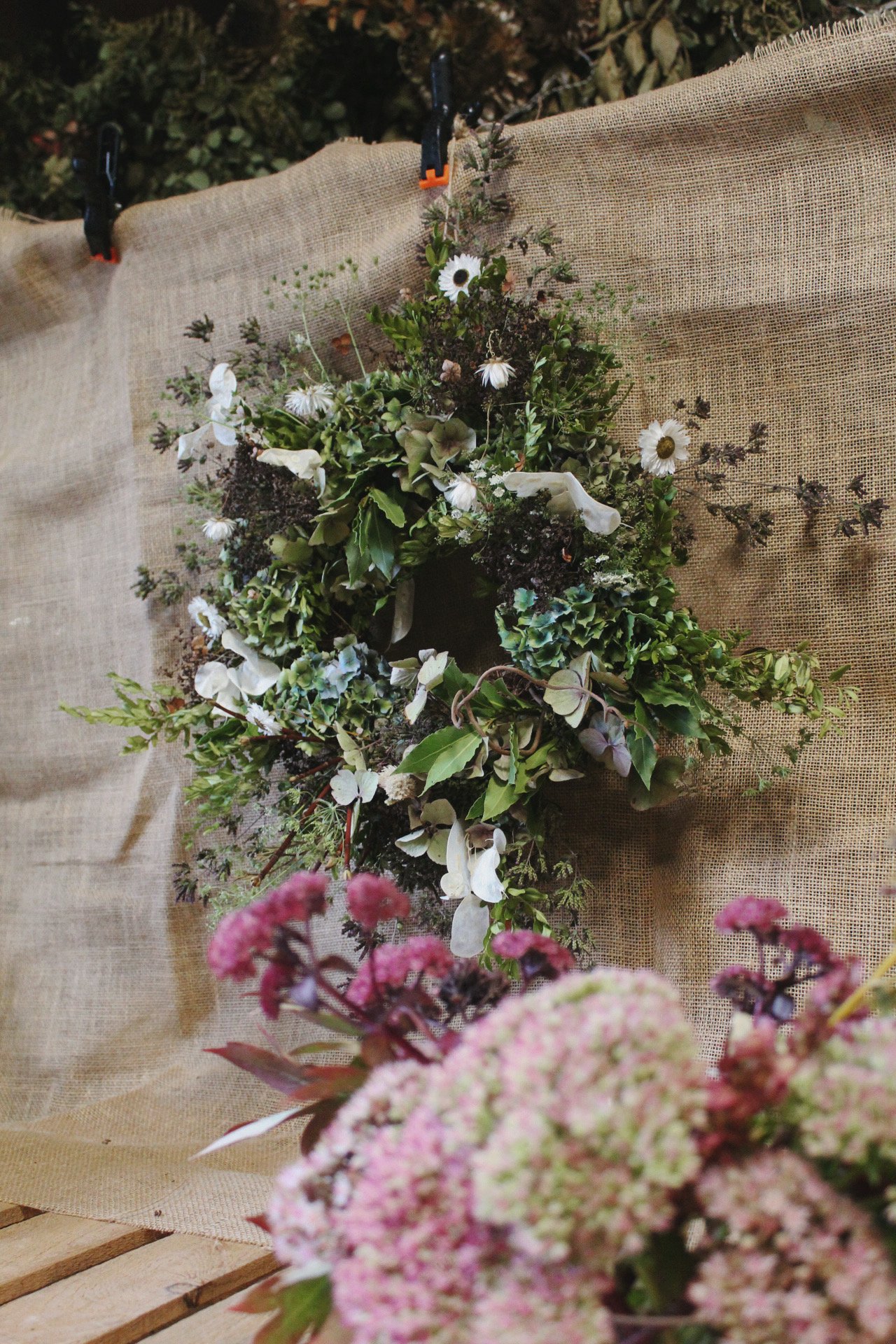 Close-up of the Autumn Arrives wreath with seasonal foliage and flowers