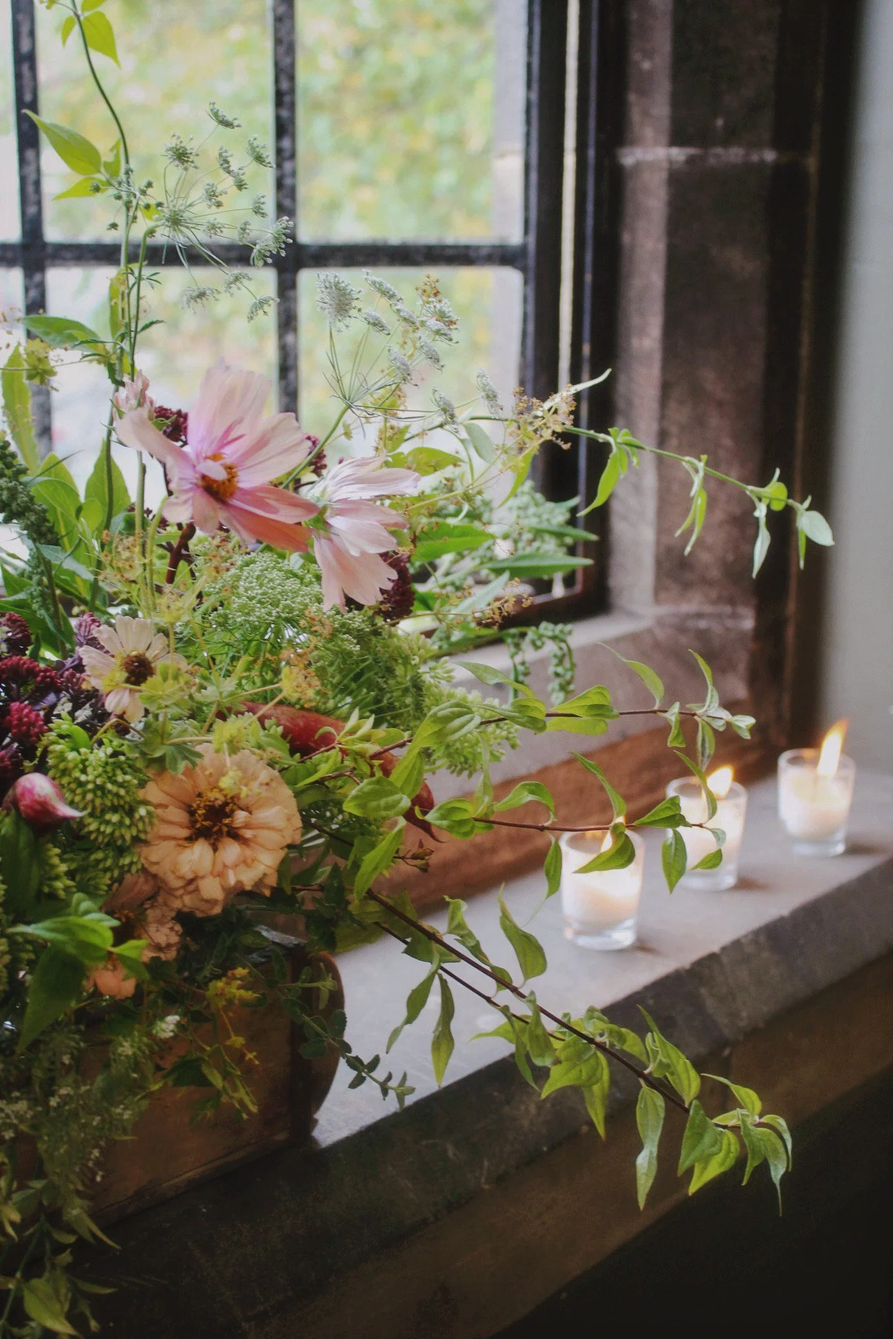 Wedding-Flower-Arrangement-with-Candle-Votives-by-the-Window..jpeg