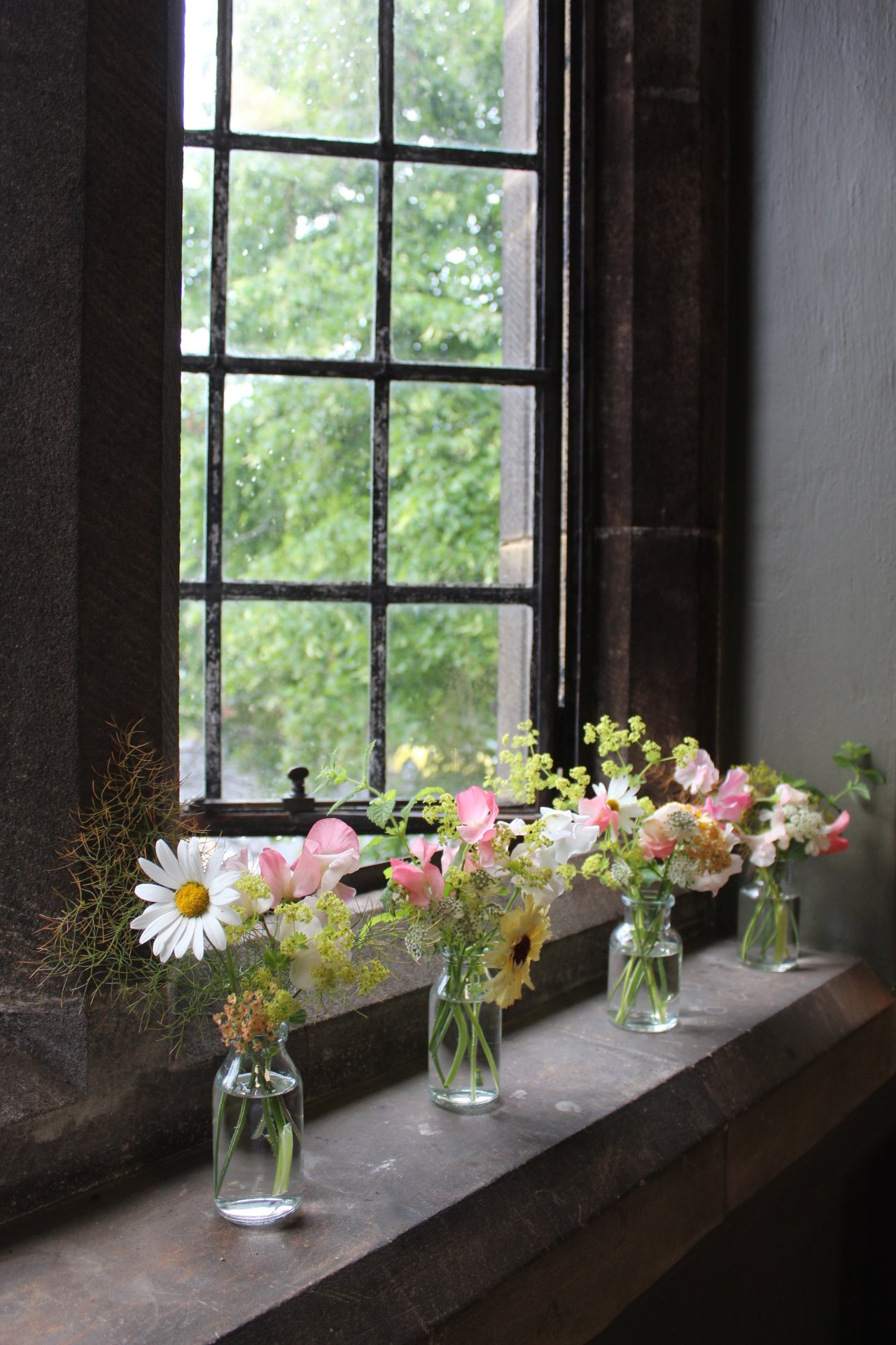 Delicate-Wedding-Arrangements-Lined-Along-the-Studio-Windowsill..jpeg