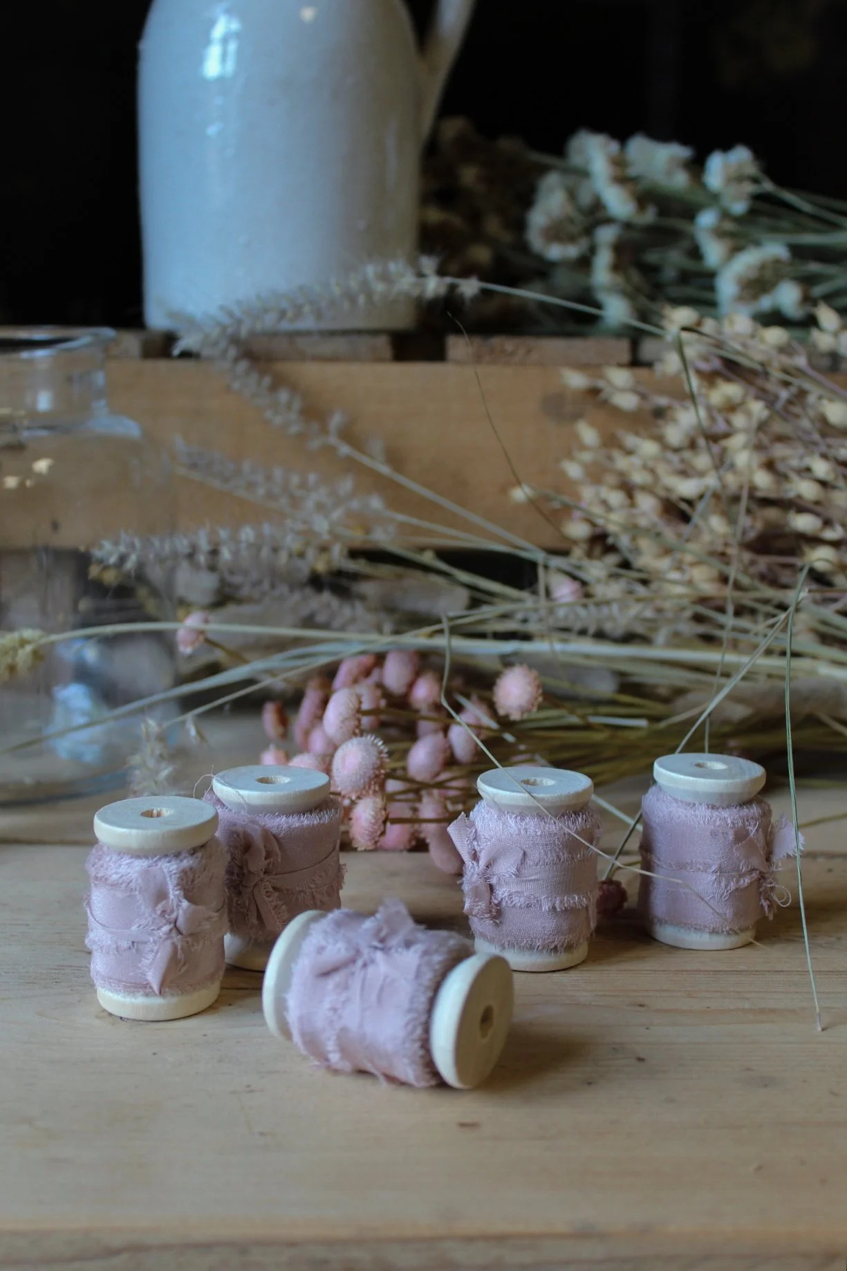 Raw edge silk ribbon on wooden reels in Putty, Nude Blush, Buttermilk, Lilac and Natural.