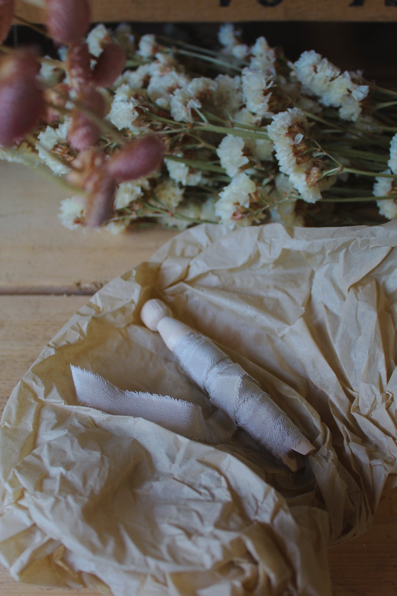 Raw edge silk ribbon on wooden reels in Putty, Nude Blush, Buttermilk, Lilac and Natural.