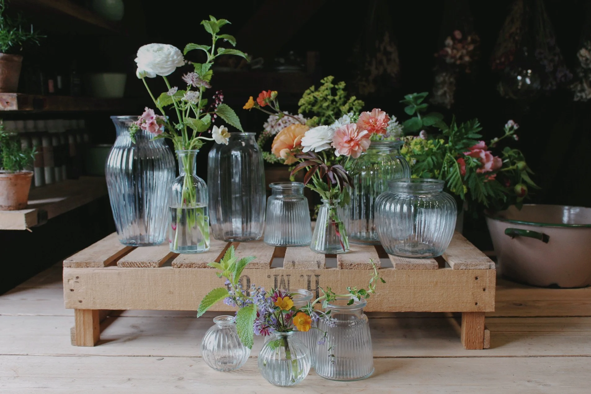 Vintage Heirloom wedding vase collection featuring ribbed and textured glass vessels filled with seasonal flowers.