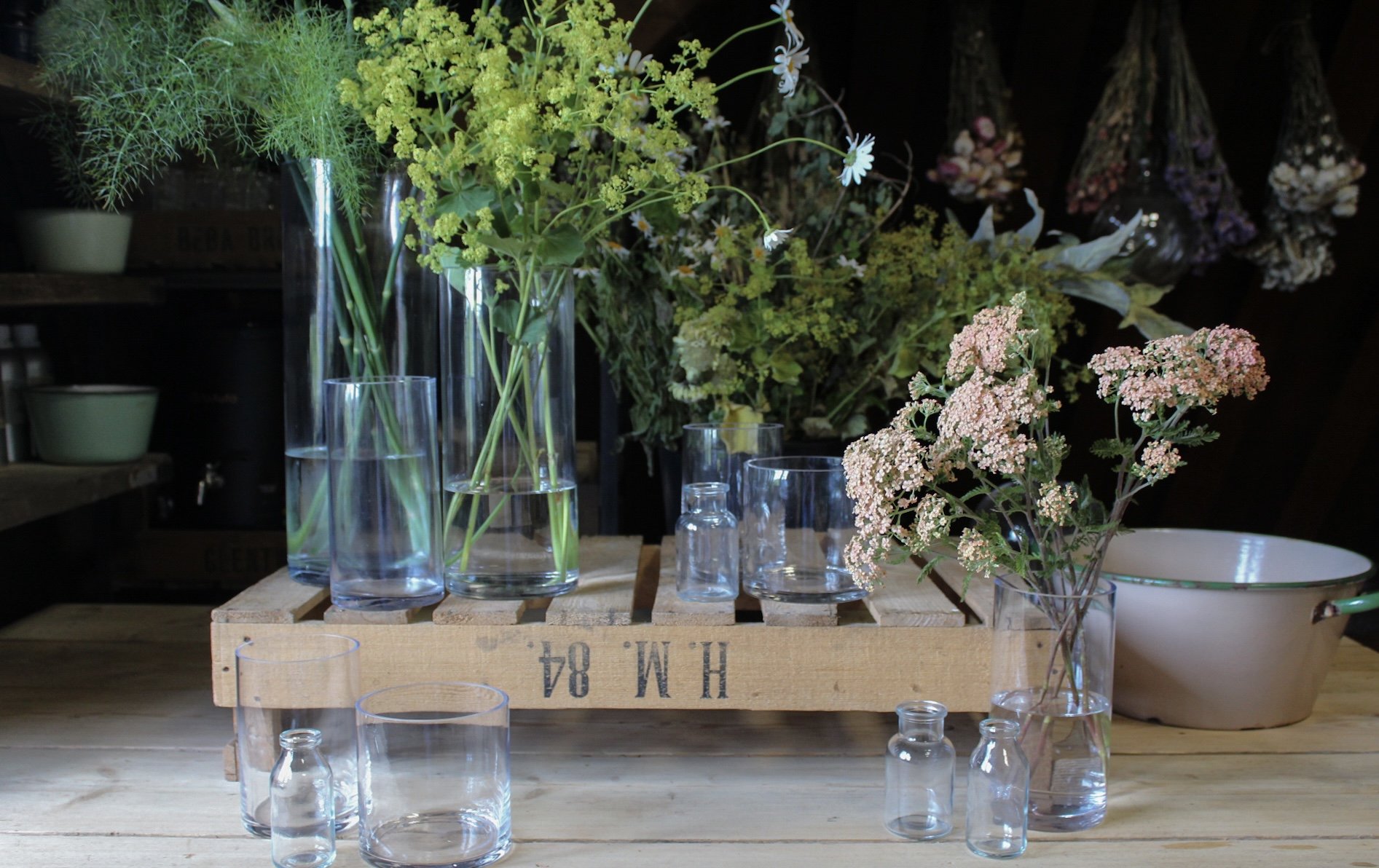 Timeless Classic wedding vase collection with clear glass vessels arranged with seasonal flowers and foliage
