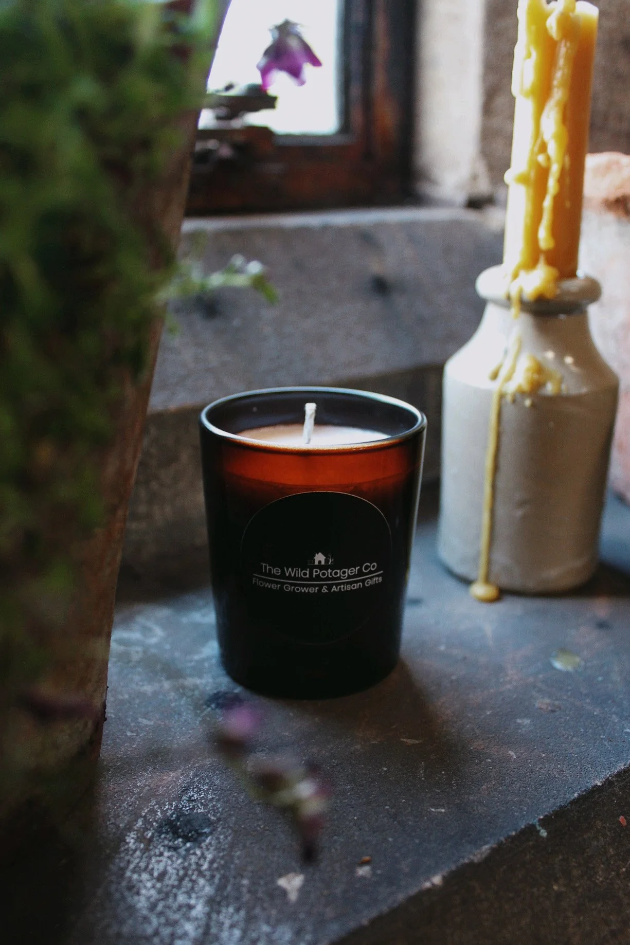 Chalk, moss and resin glass candles from The Wild Potager Co. photographed together in the potager studio.
