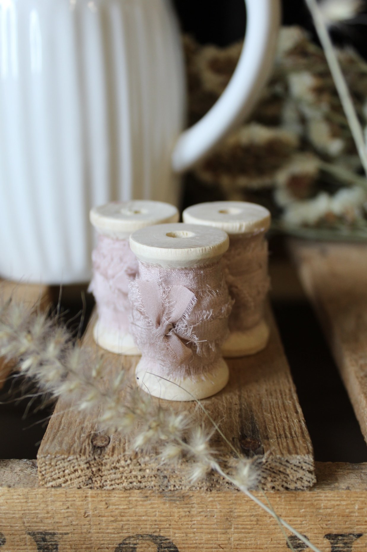 Raw edge silk ribbon on wooden reels in Putty, Nude Blush, Buttermilk, Lilac and Natural.