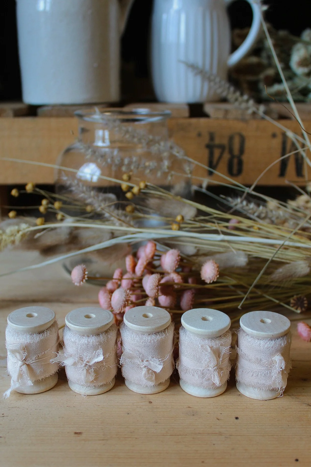 Raw edge silk ribbon on wooden reels in Putty, Nude Blush, Buttermilk, Lilac and Natural.