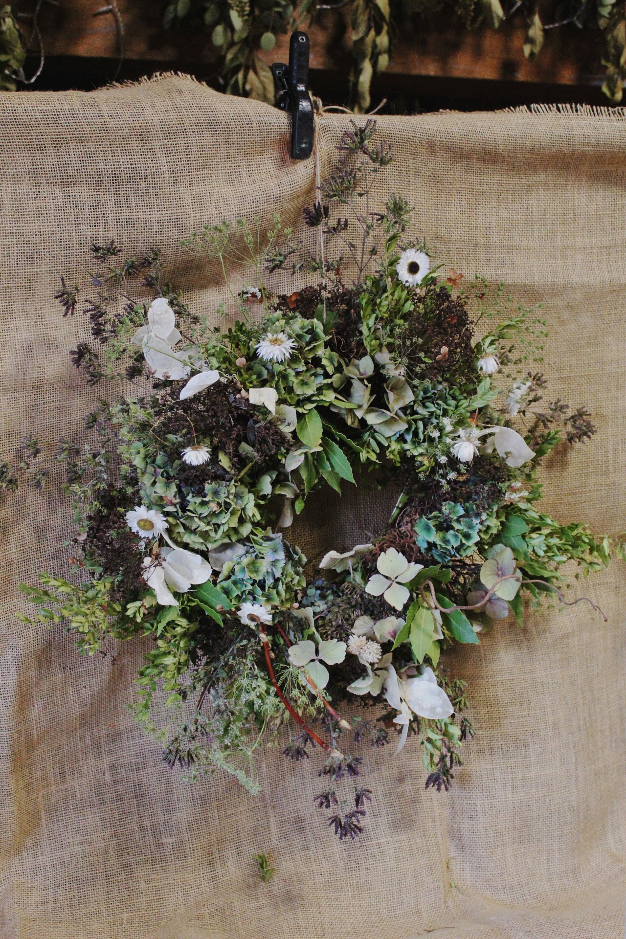 Close-up of the Autumn Arrives wreath with seasonal foliage and flowers