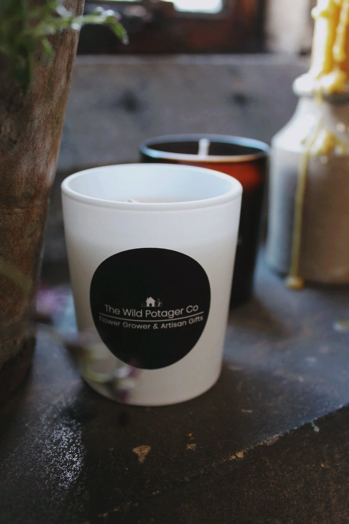 Chalk, moss and resin glass candles from The Wild Potager Co. photographed together in the potager studio.