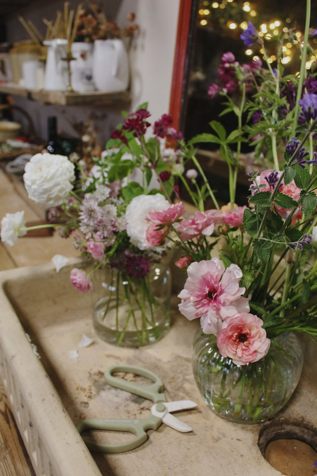 Working with flowers and arranging them for a wedding on the studio workbench.