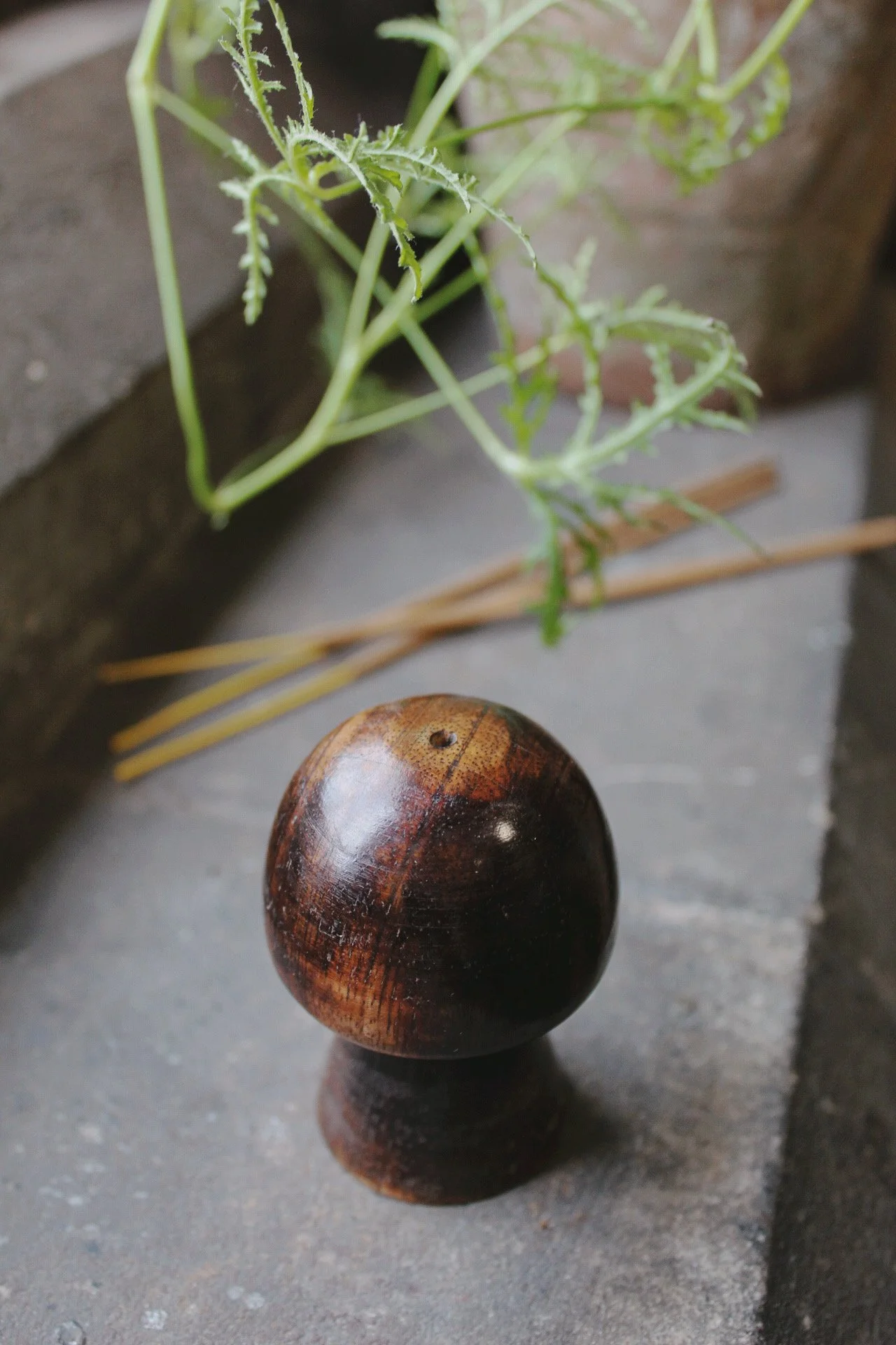 Round wooden incense holder with incense sticks