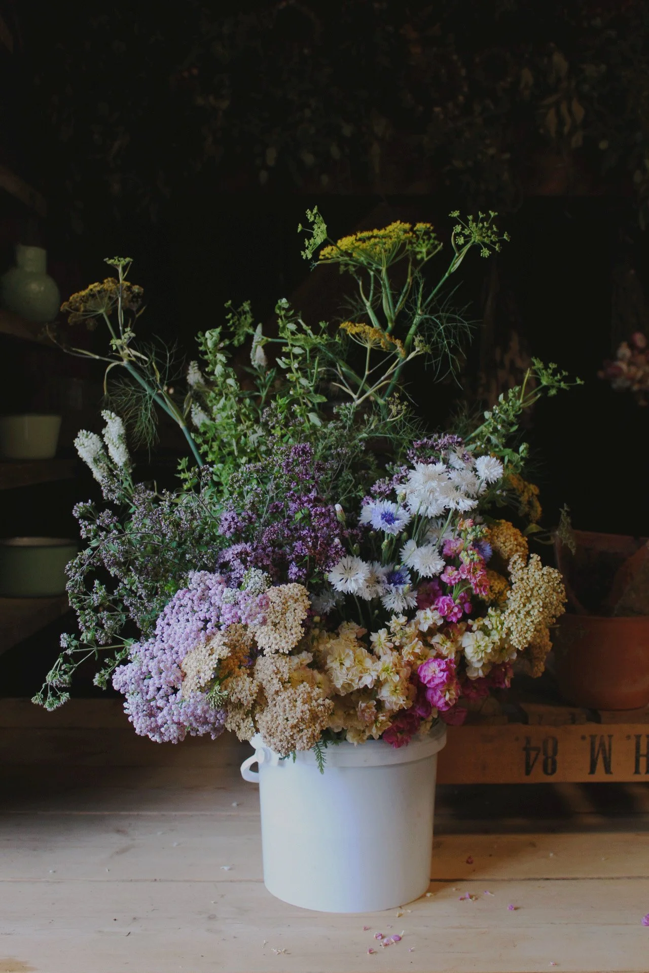Seasonal DIY flower bucket filled with freshly cut purple, white, yellow and pink flowers and foliage from The Wild Potager Co.