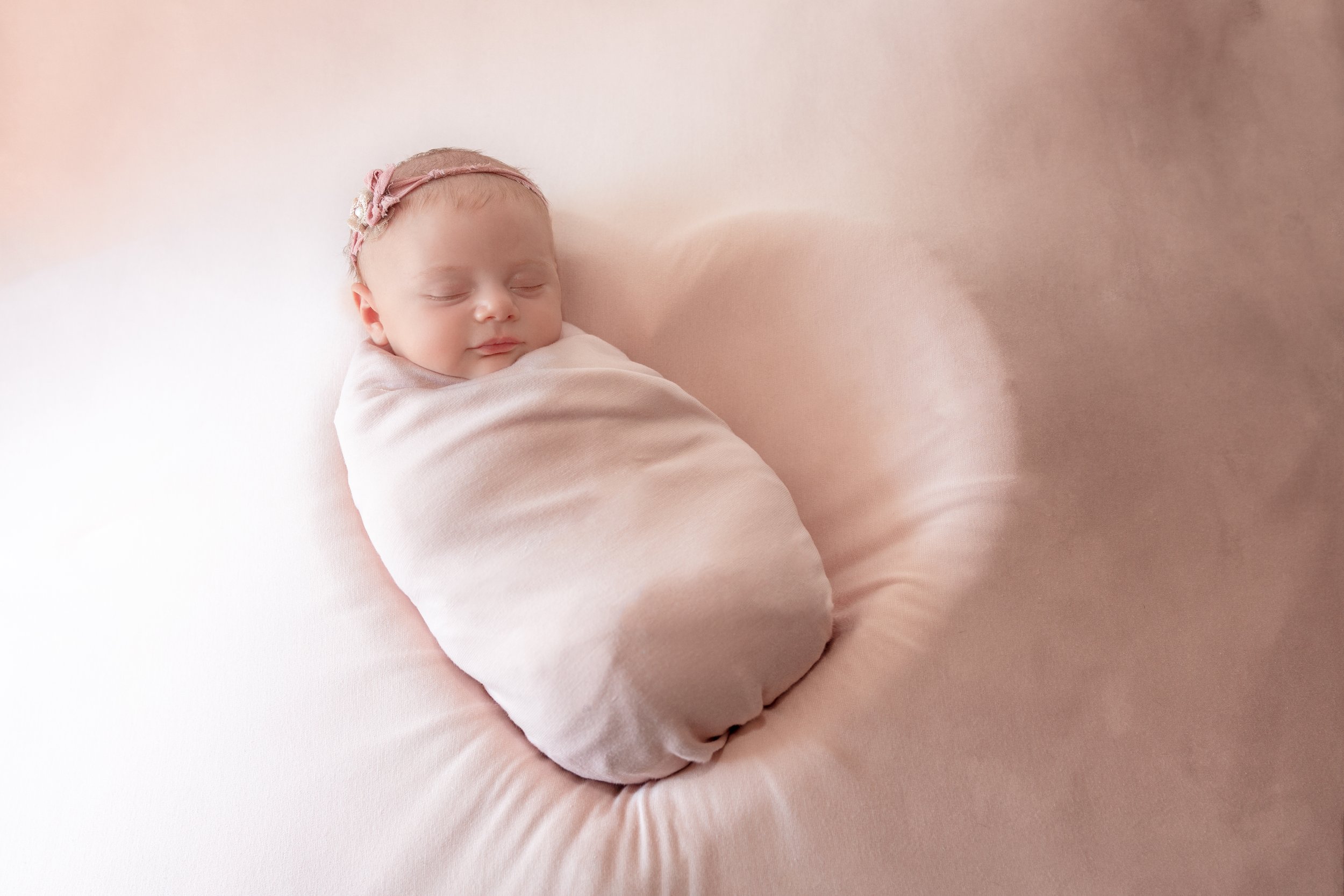 newborn photography baby girl in pink in heart shaped bowl