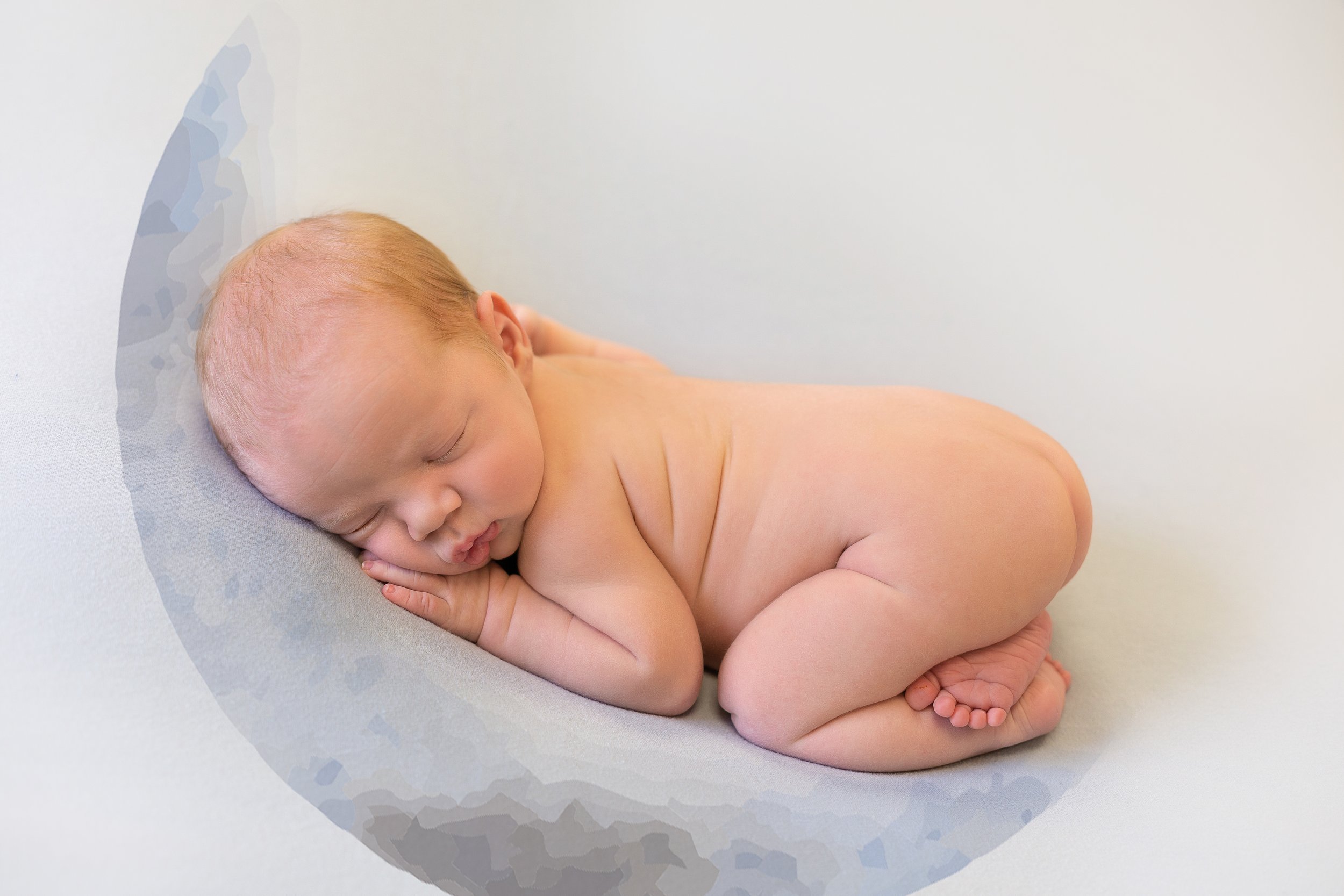 newborn in bum up pose on moon blanket