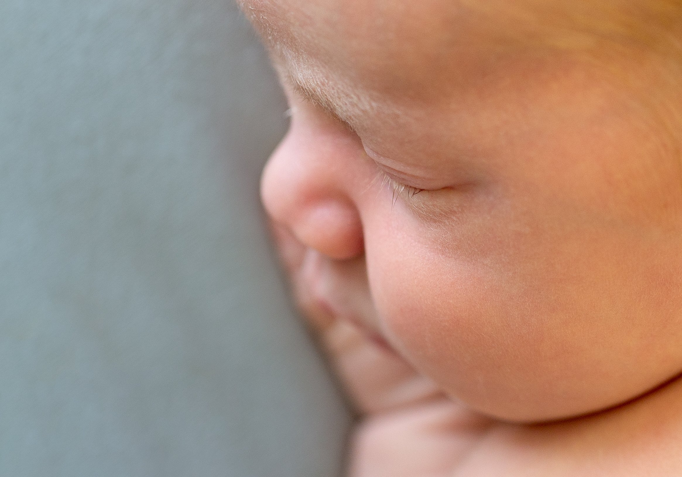 close up photo of newborn with long eyelashes