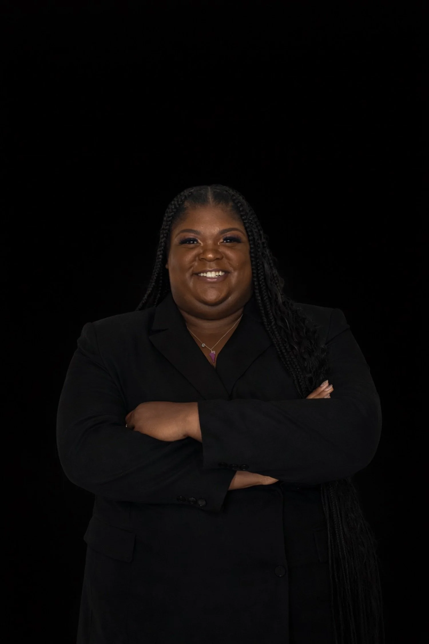 Tyra Steverson, LCPC, LPC, smiling with arms crossed in a black blazer