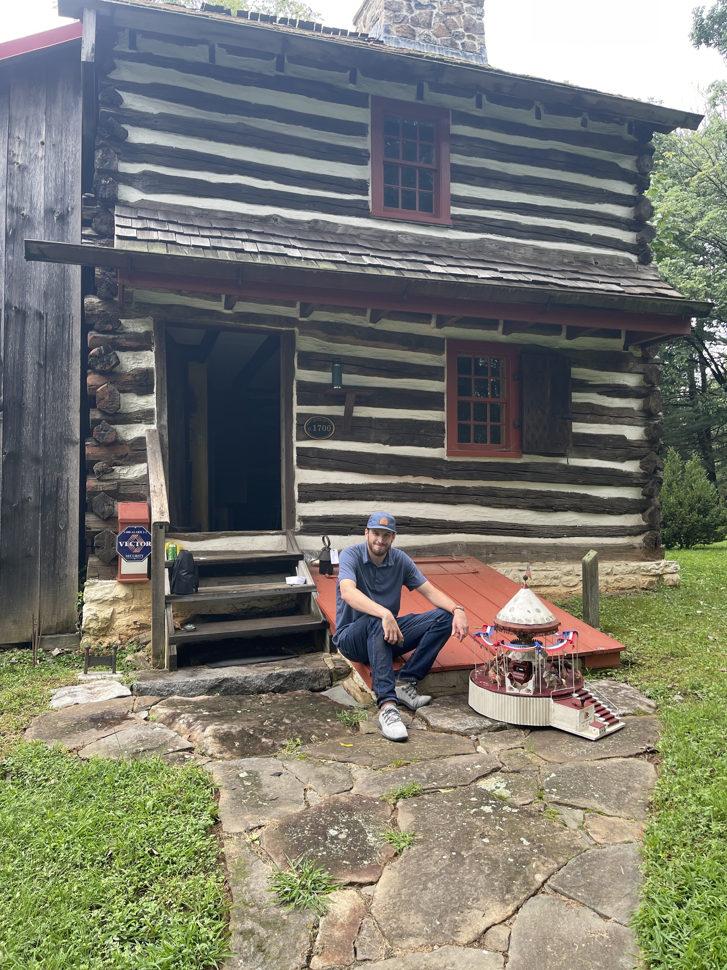 Stephen cataloging outside of the log house