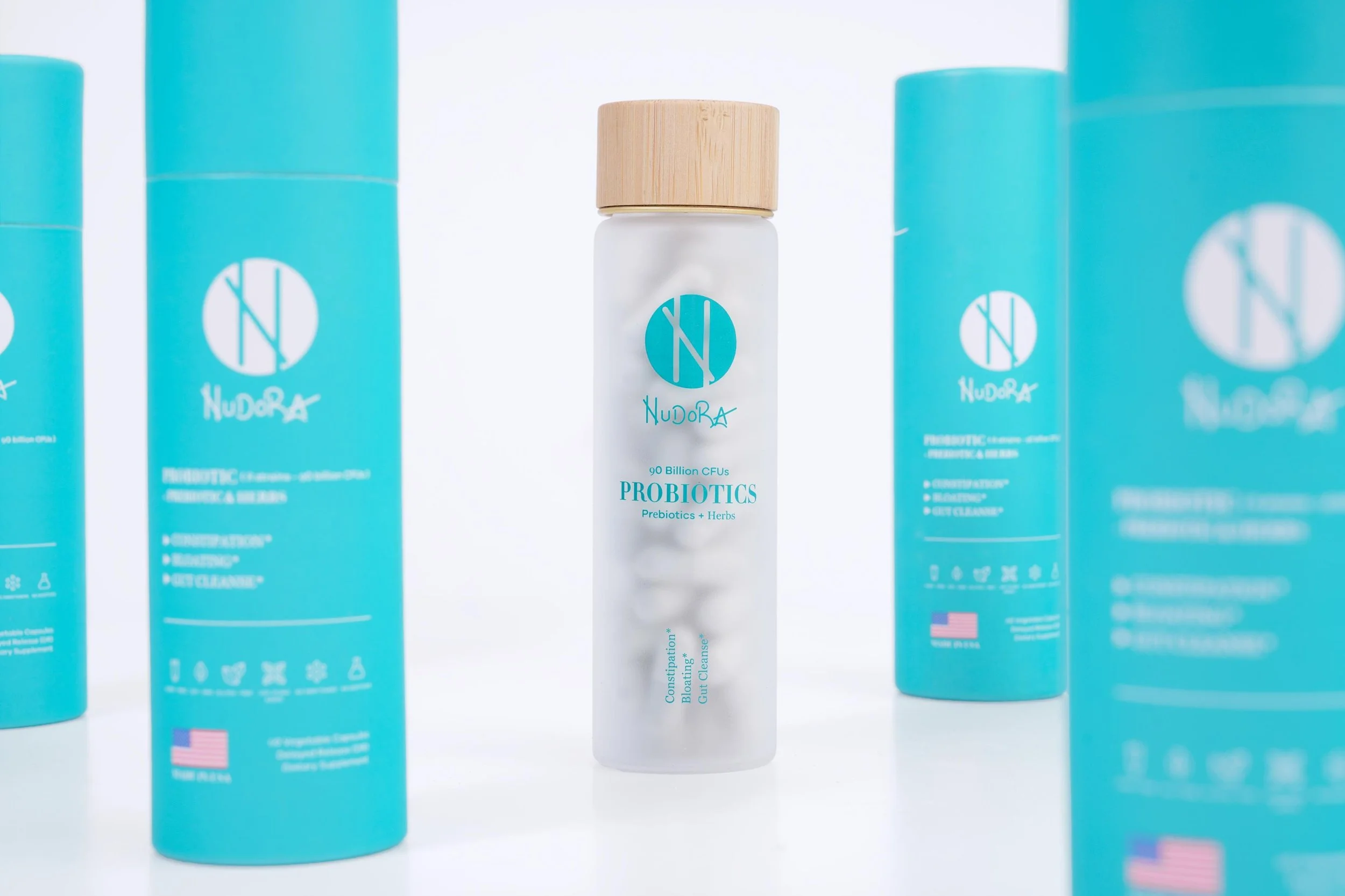 Probiotic supplement bottle photographed with branded packaging in a clean studio composition for ecommerce