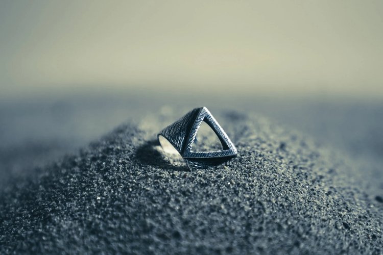 Men's silver rings and bracelets worn at golden hour