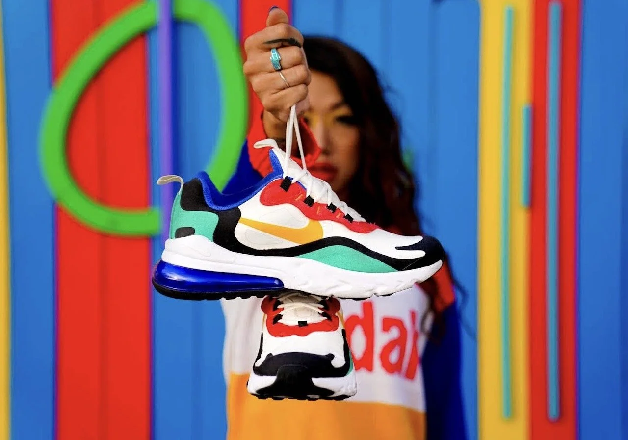 Los Angeles product photography, Nike sneakers in colorful lifestyle campaign shoot with model, bold studio backdrop