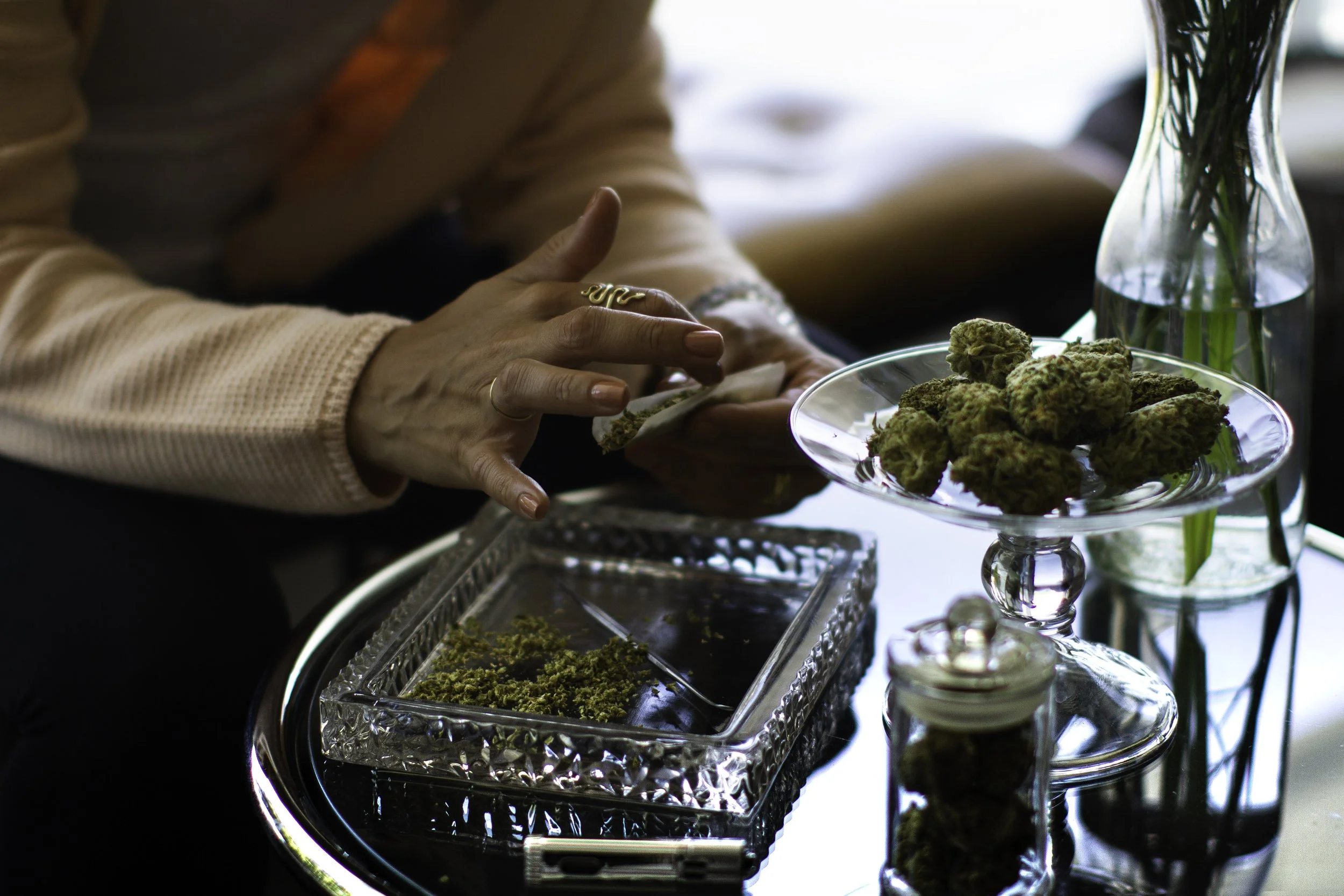 California cannabis lifestyle photography of flower preparation scene with hands and cannabis buds