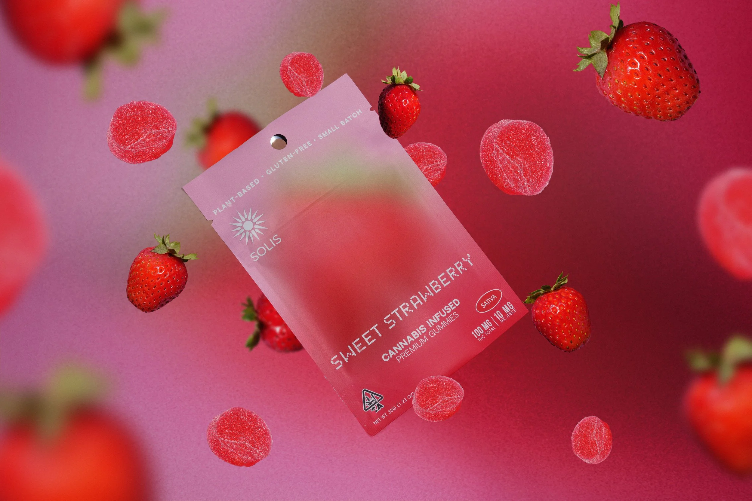 Sweet Strawberry cannabis gummy package flatlay with strawberries — lifestyle product photographer Los Angeles