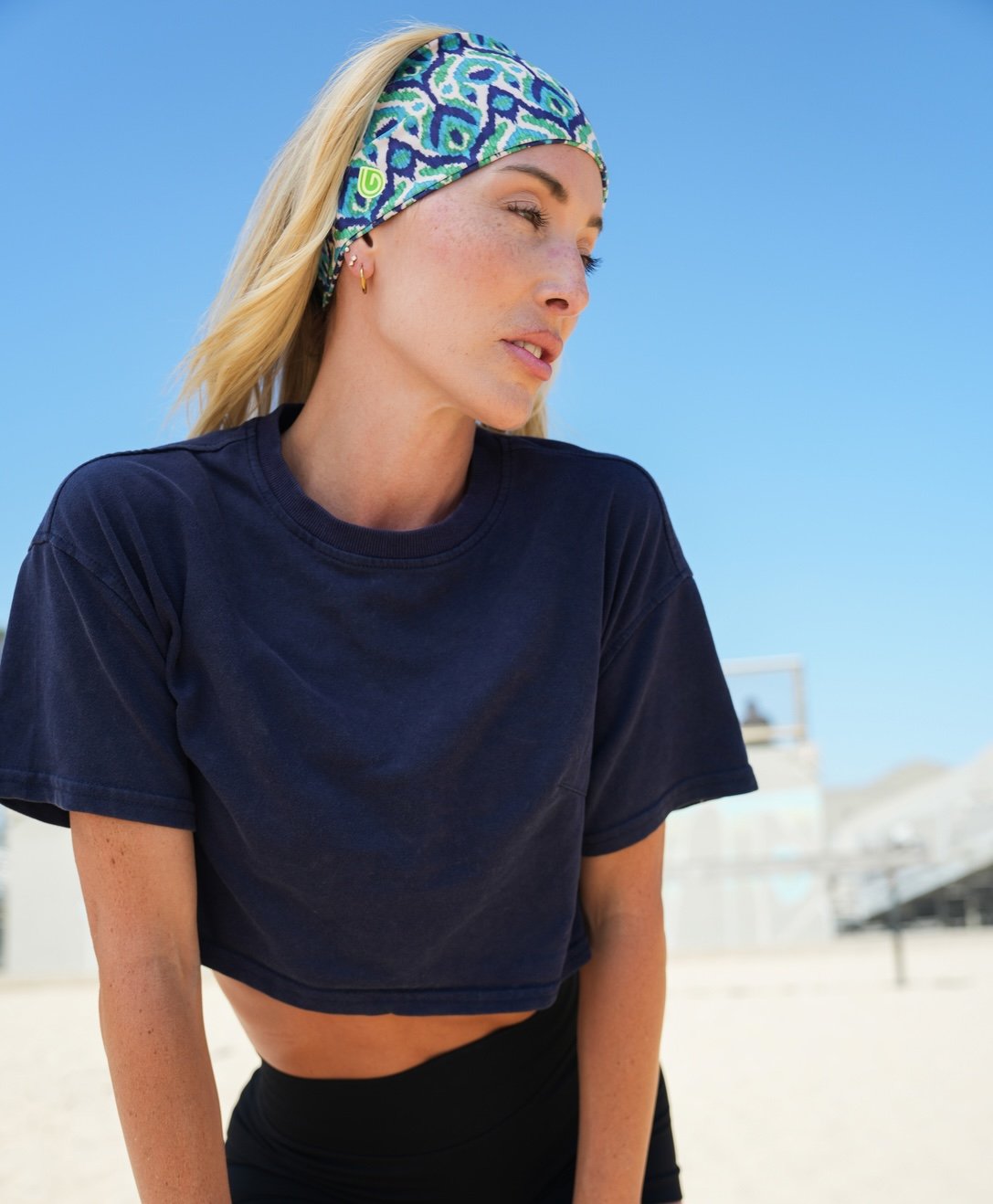 GymWrap headband lifestyle photoshoot, woman in a patterned headband and navy top outdoors