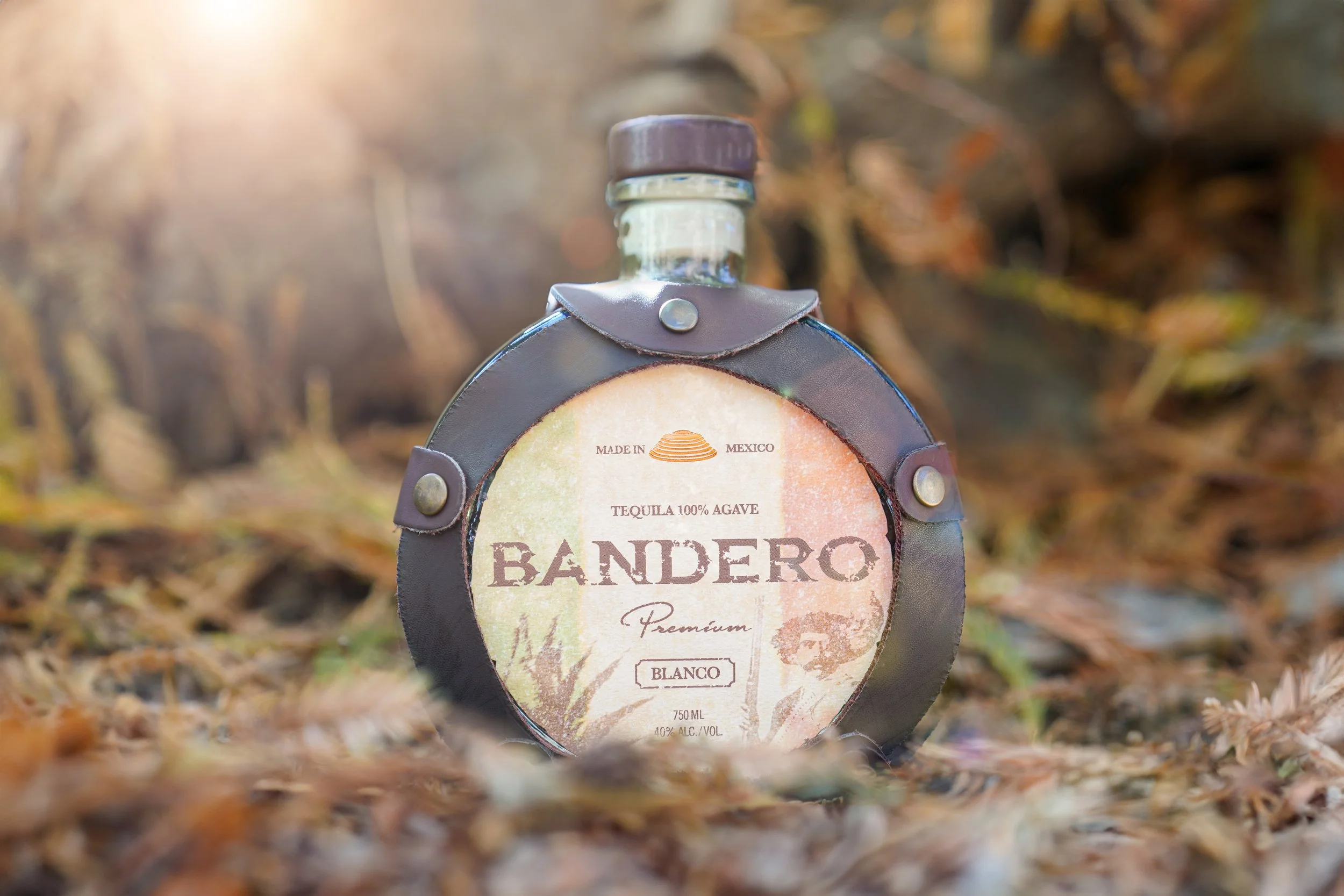 Bandero Premium Blanco tequila bottle on forest floor — spirits product photographer Los Angeles