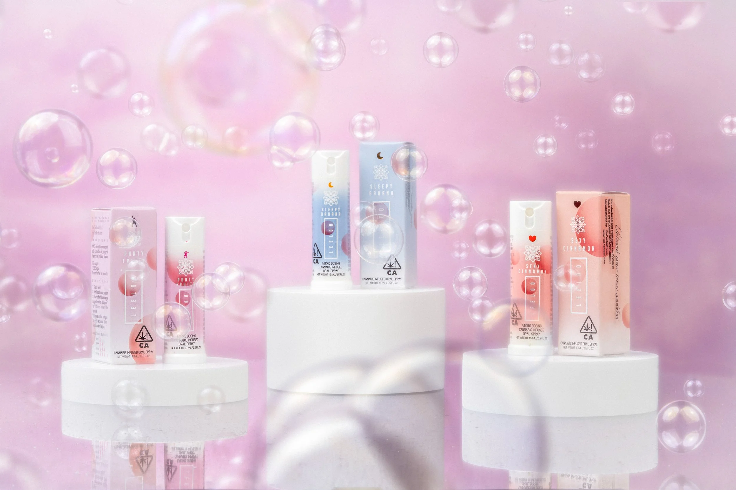 Colorful wellness supplement products displayed on white pedestals with floating bubbles