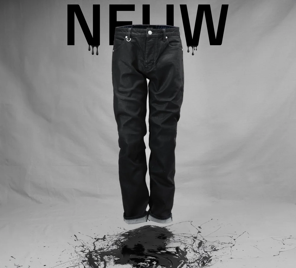 Conceptual commercial fashion photograph of black trousers against a monochrome NEUW graphic, using controlled studio light and subtle tonal separation to retain texture in the black fabric while preserving the minimalist advertising design