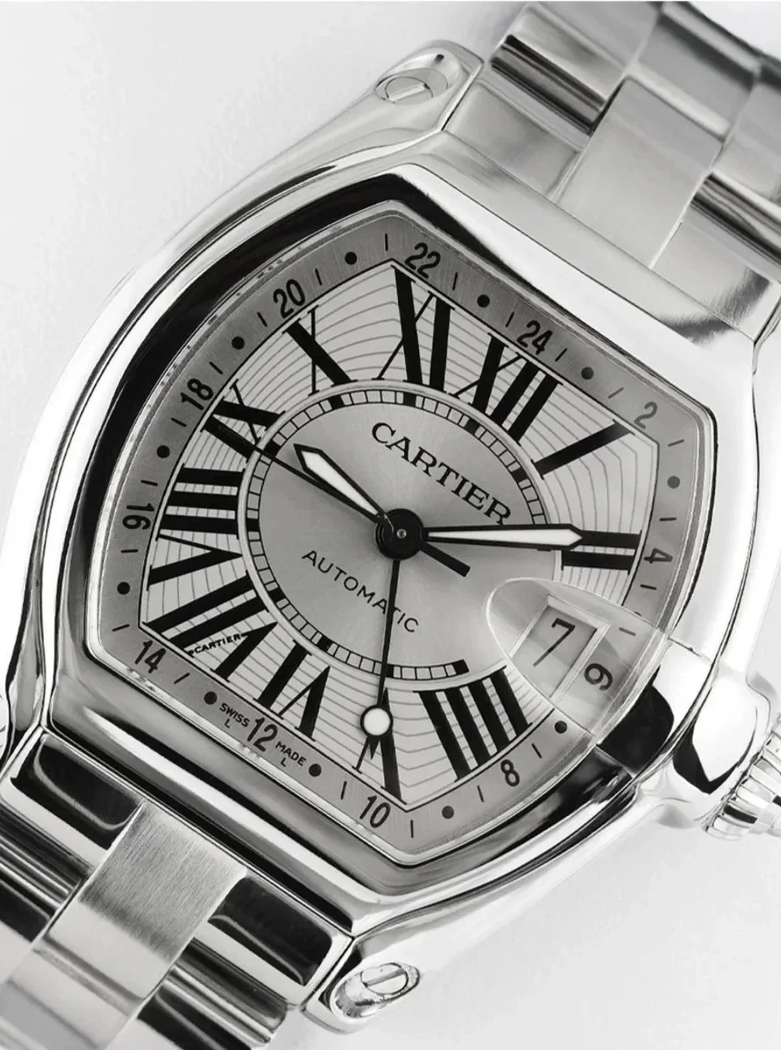Cartier Roadster watch with polished steel case and Roman numeral dial, photographed with controlled lighting to manage reflections