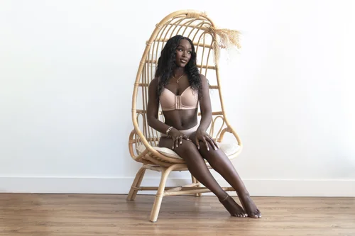 Fall lingerie campaign on model in a rattan chair
