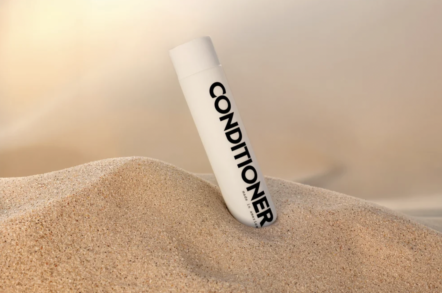 Days of Dirt conditioner bottle styled upright in warm sand with soft golden studio lighting